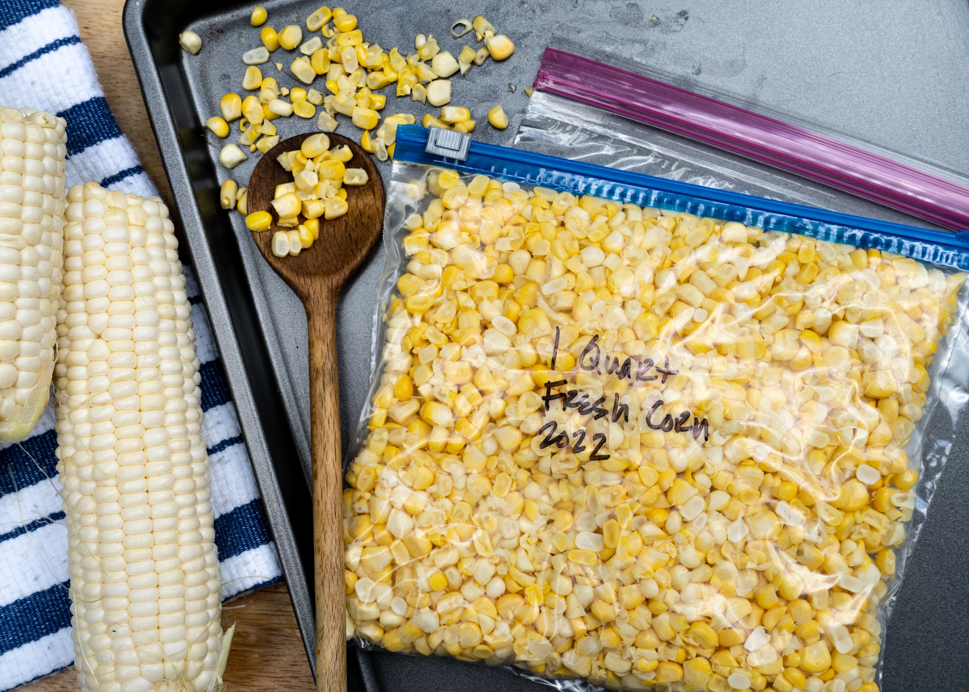 To freeze fresh corn, simply cut the kernels off the cob, place in freezer-grade plastic bags, press to remove the air, then flatten and seal. Chadwick Boyd for The Atlanta Journal-Constitution