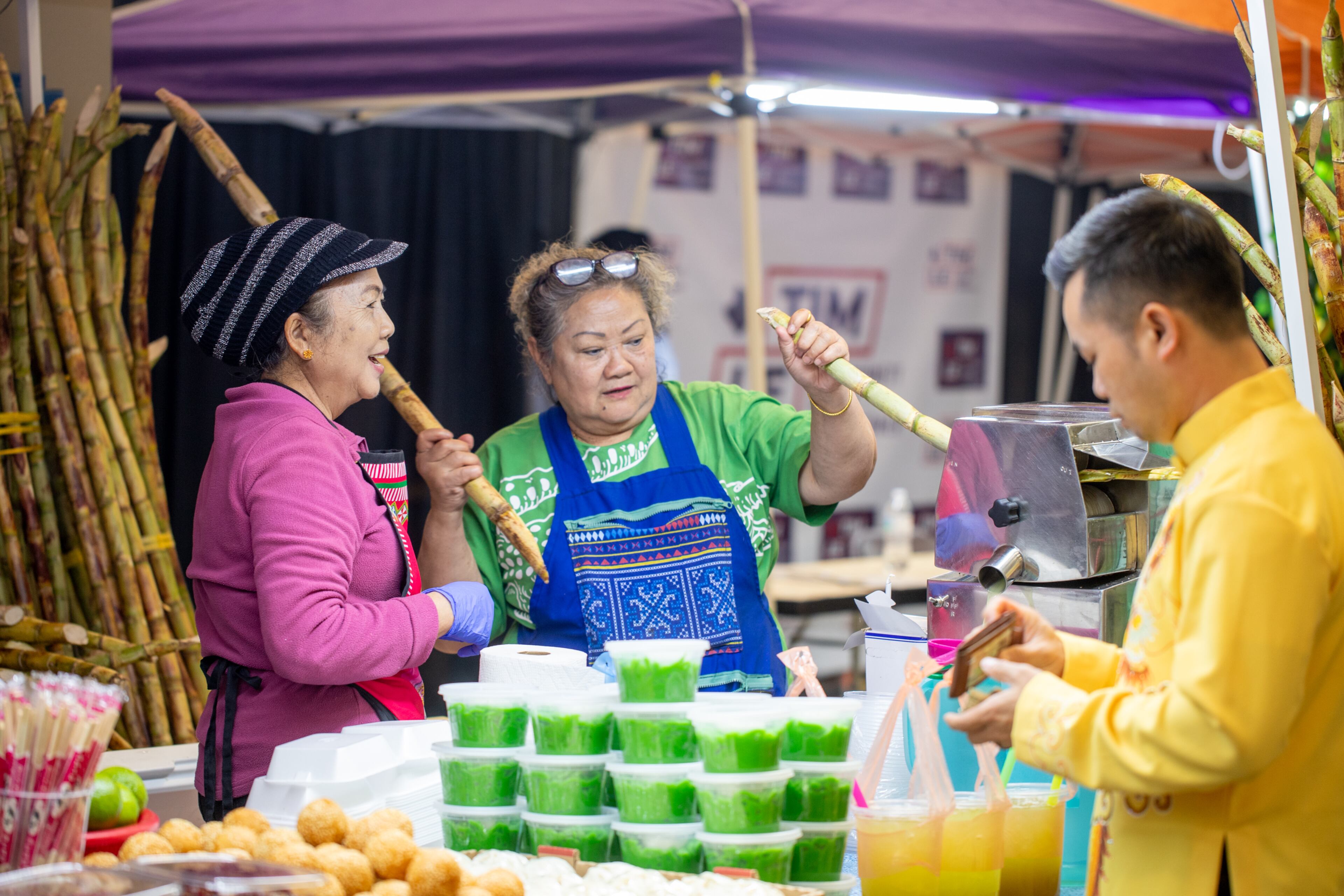 Van K’tayong makes sugar cane drink with help from Panh Wagdsjlsm, left, as the festivities of the Lunar New Year begin on Saturday, Feb 3, 2024. The Vietnamese American Community of Georgia hosts the celebration at Plaza Las Americas in Lilburn where dragon and lion dancing, firecrackers and drumming opened the weekend. The celebration continues on Sunday and includes traditional food, music and cultural festivities. (Jenni Girtman for The Atlanta Journal-Constitution)