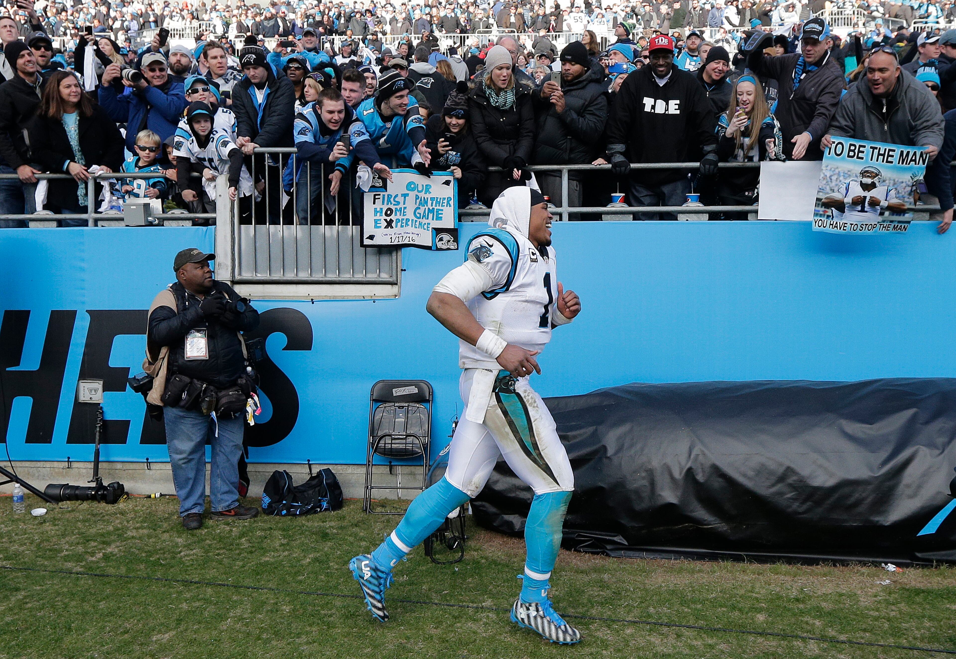 Carolina Panthers quarterback Cam Newton (1) celebrates with fans after the second half of an NFL divisional playoff football game against the Seattle Seahawks, Sunday, Jan. 17, 2016, in Charlotte, N.C. The Panthers won 31-24. (AP Photo/Chuck Burton)
