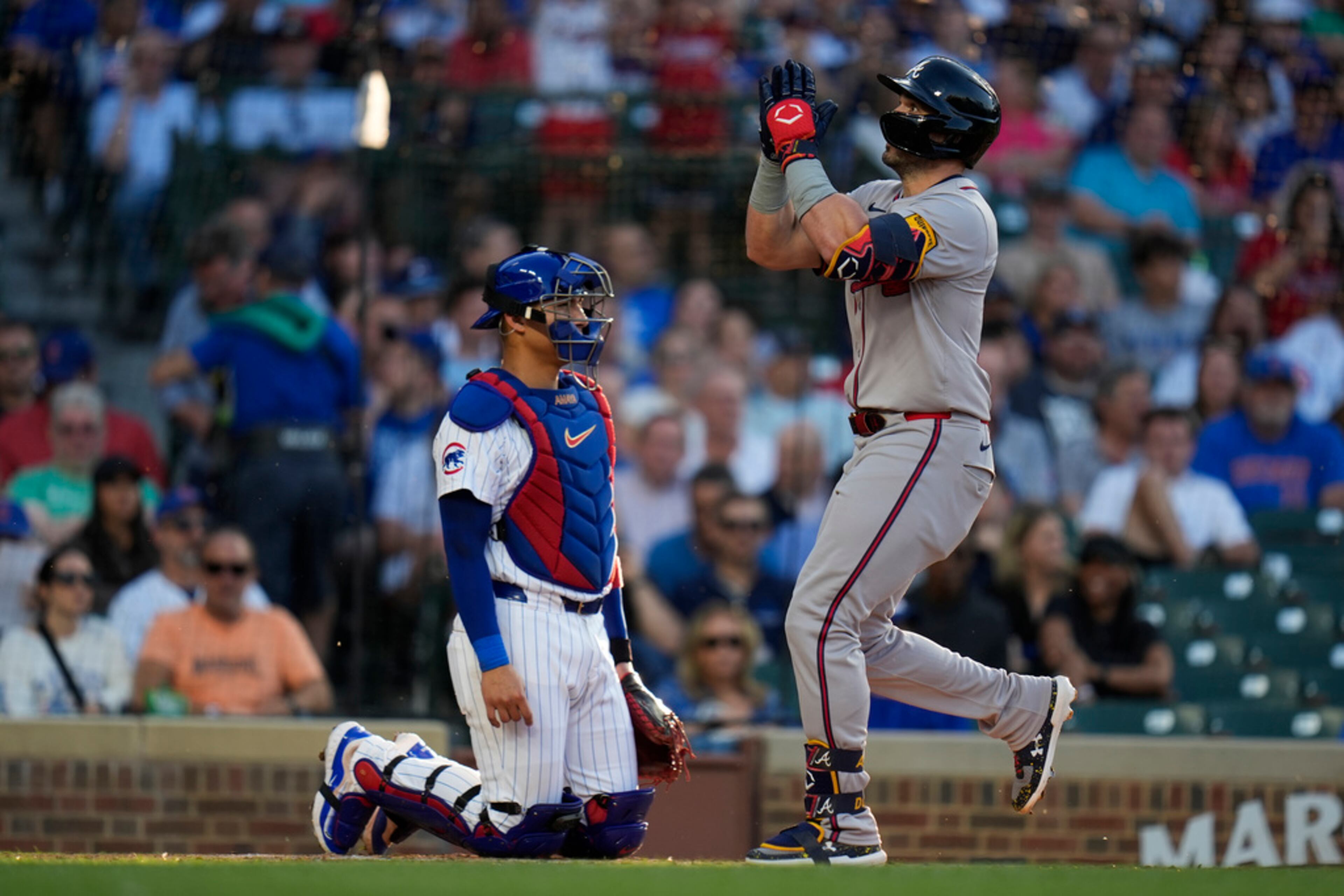 Atlanta Braves' Adam Duvall, right, jogs past Chicago Cubs catcher Miguel Amaya after hitting a home run during the third inning of a baseball game Wednesday, May 22, 2024, in Chicago. (AP Photo/Erin Hooley)