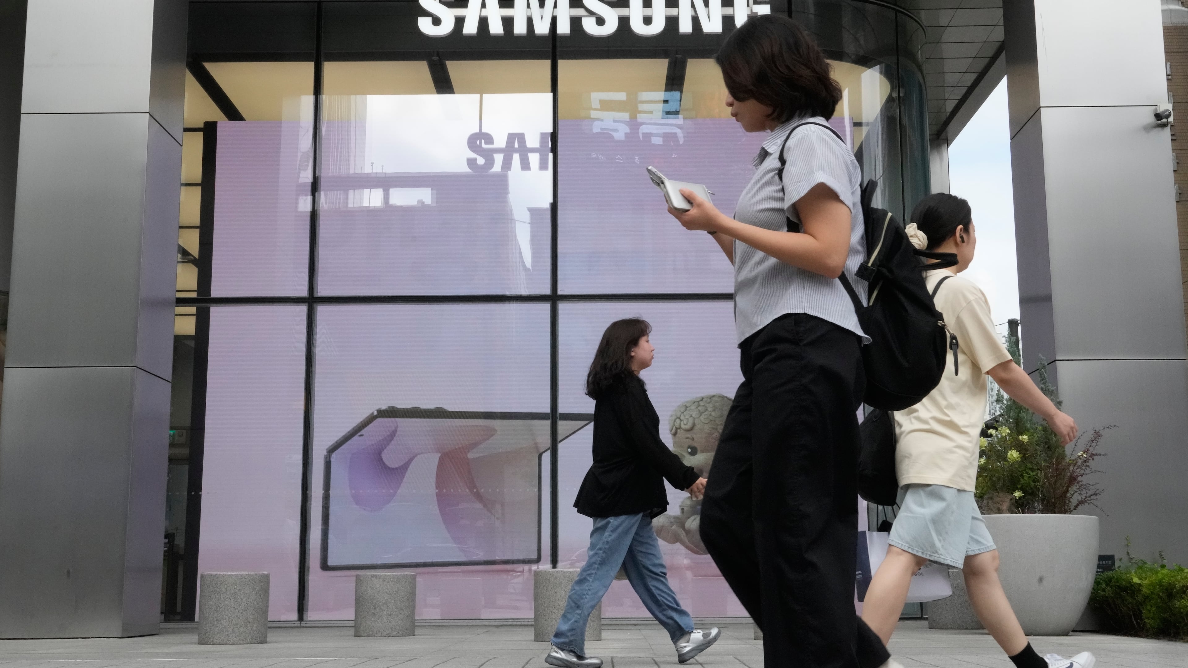 People pass by Samsung Gangnam store in Seoul, South Korea, Thursday, July 30, 2026. (AP Photo/Ahn Young-joon)