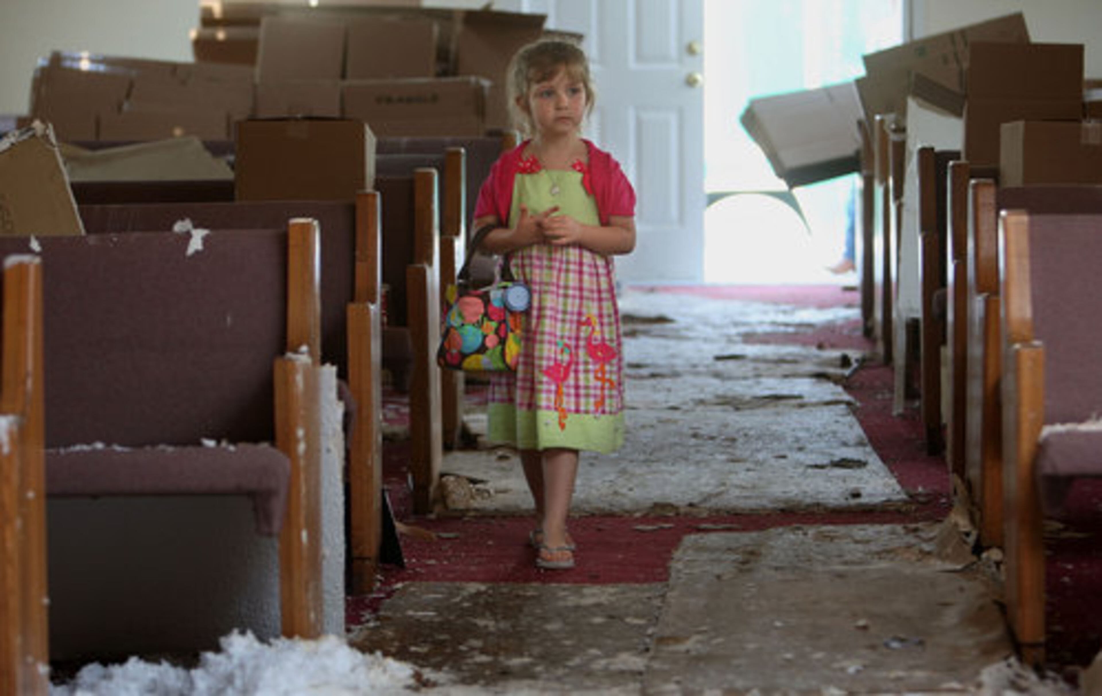 Kaylin Alred, 7, walks the aisle where she would sit in one of the pews each Sunday with her family before it was destroyed by last week's twister at Crowe Springs Baptist Church in Cartersville Sunday, May 1, 2011. The church of about 100 members held their Sunday service at the church parking lot.