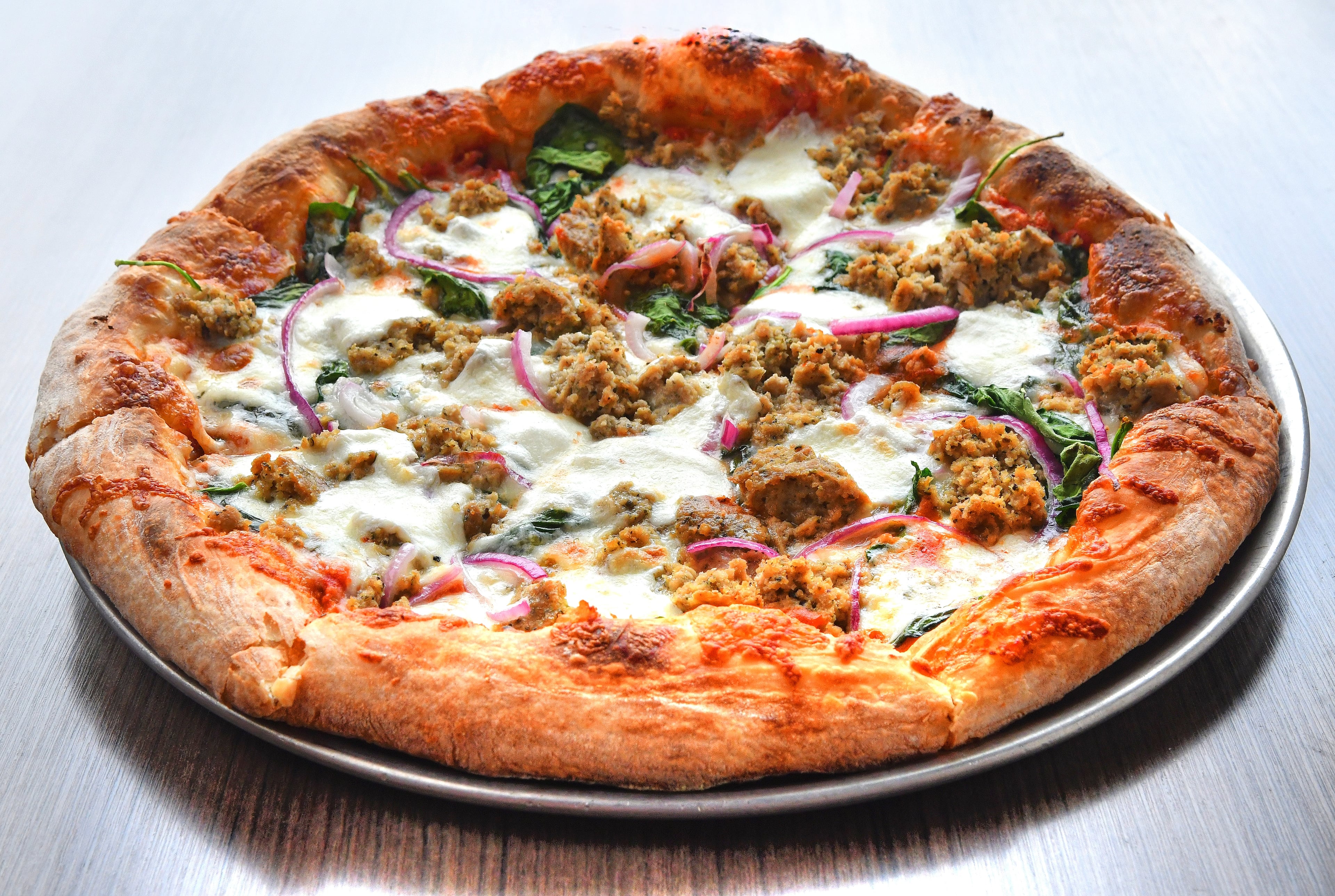 Diners at Firepit Pizza Tavern will find a menu of sandwiches, wings, salads and pizza, including their Meatball Pizza. (Chris Hunt for the AJC)