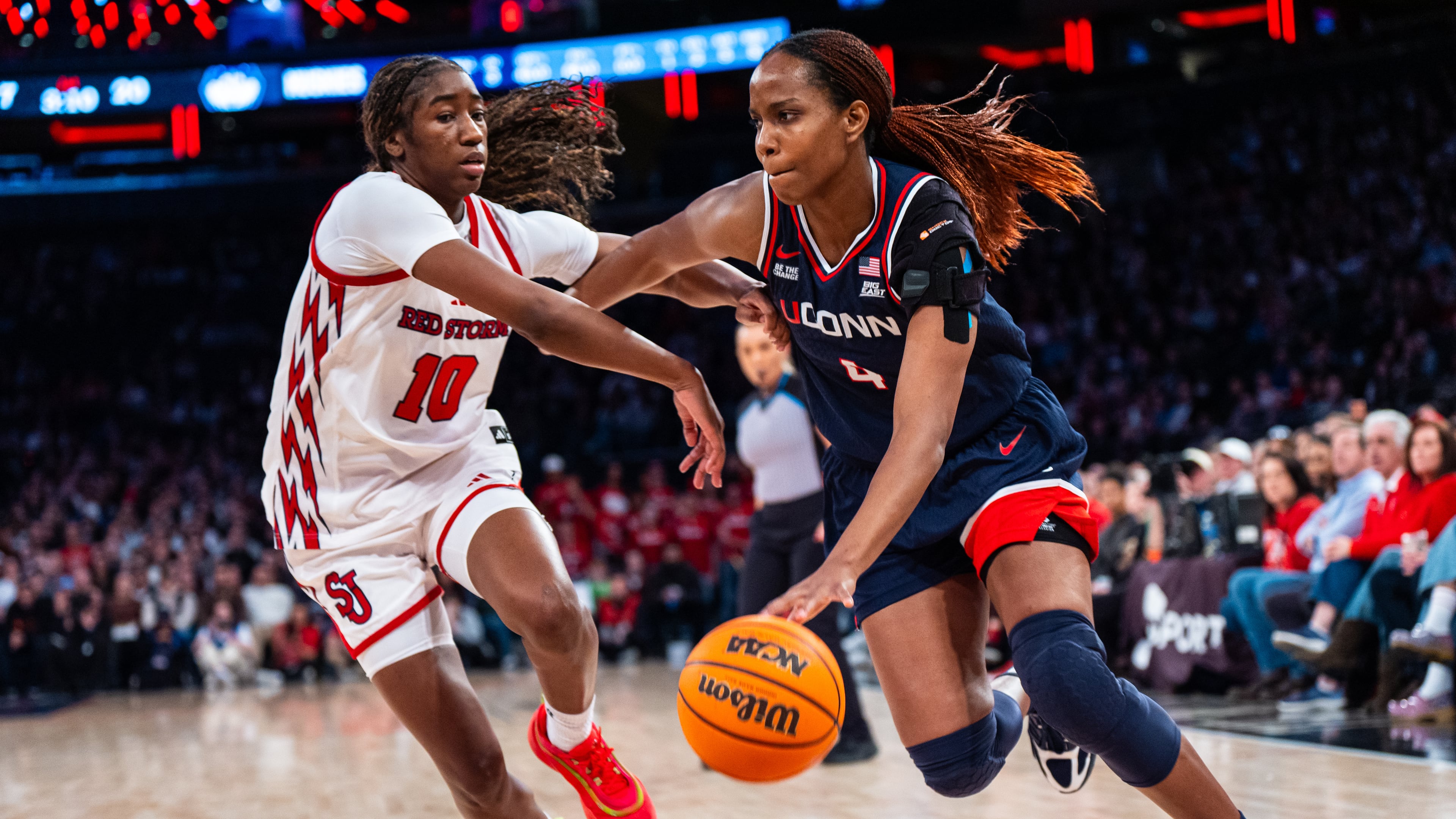 UConn guard Blanca Quinonez (4), guarded by St. John's guard Brooke Moore (10), heads toward the basket during the first half of an NCAA college basketball game, Sunday, March 1, 2026, in New York. (AP Photo/Angelina Katsanis)