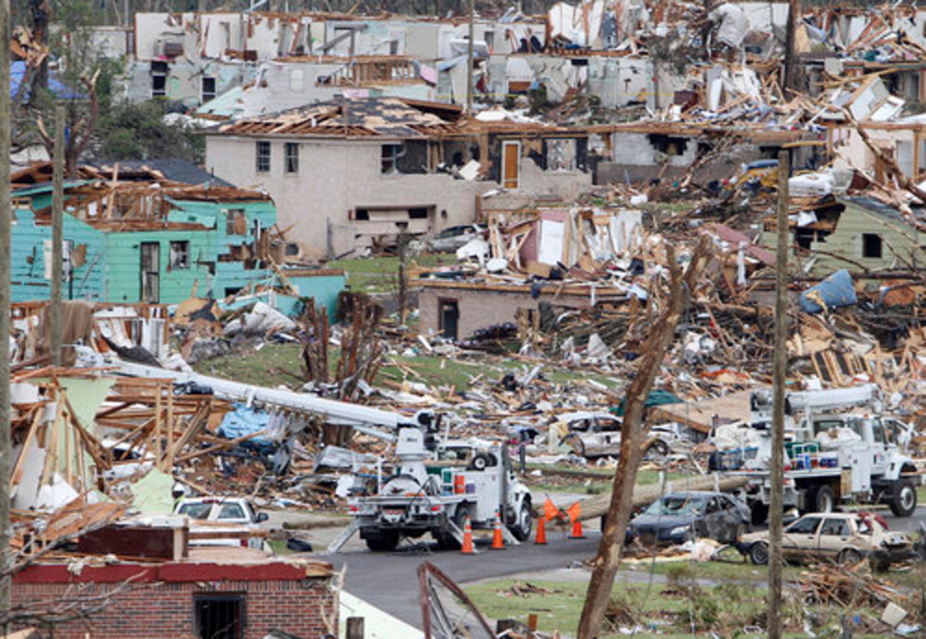 STORMS' SLOW RECOVERY--Utility companies set new power poles in Pratt City, Ala., Tuesday, May 3, 2011, as storms move into the area already severely damaged by tornadoes the week before.