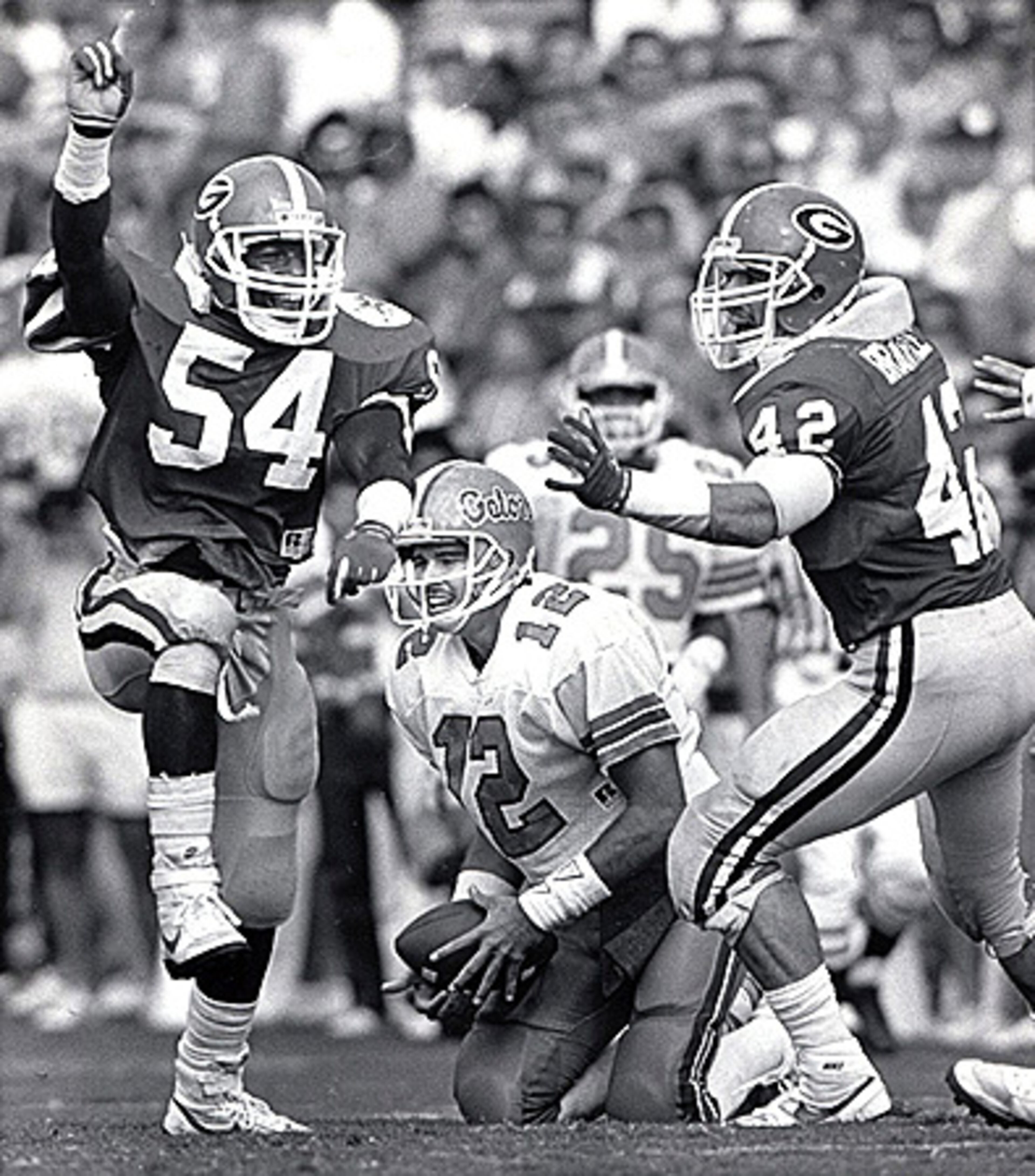 In 1987, Georgia defenders Vince Guthrie (54) and John Brantley (42) celebrate after sacking Florida quarterback Kerwin Bell.