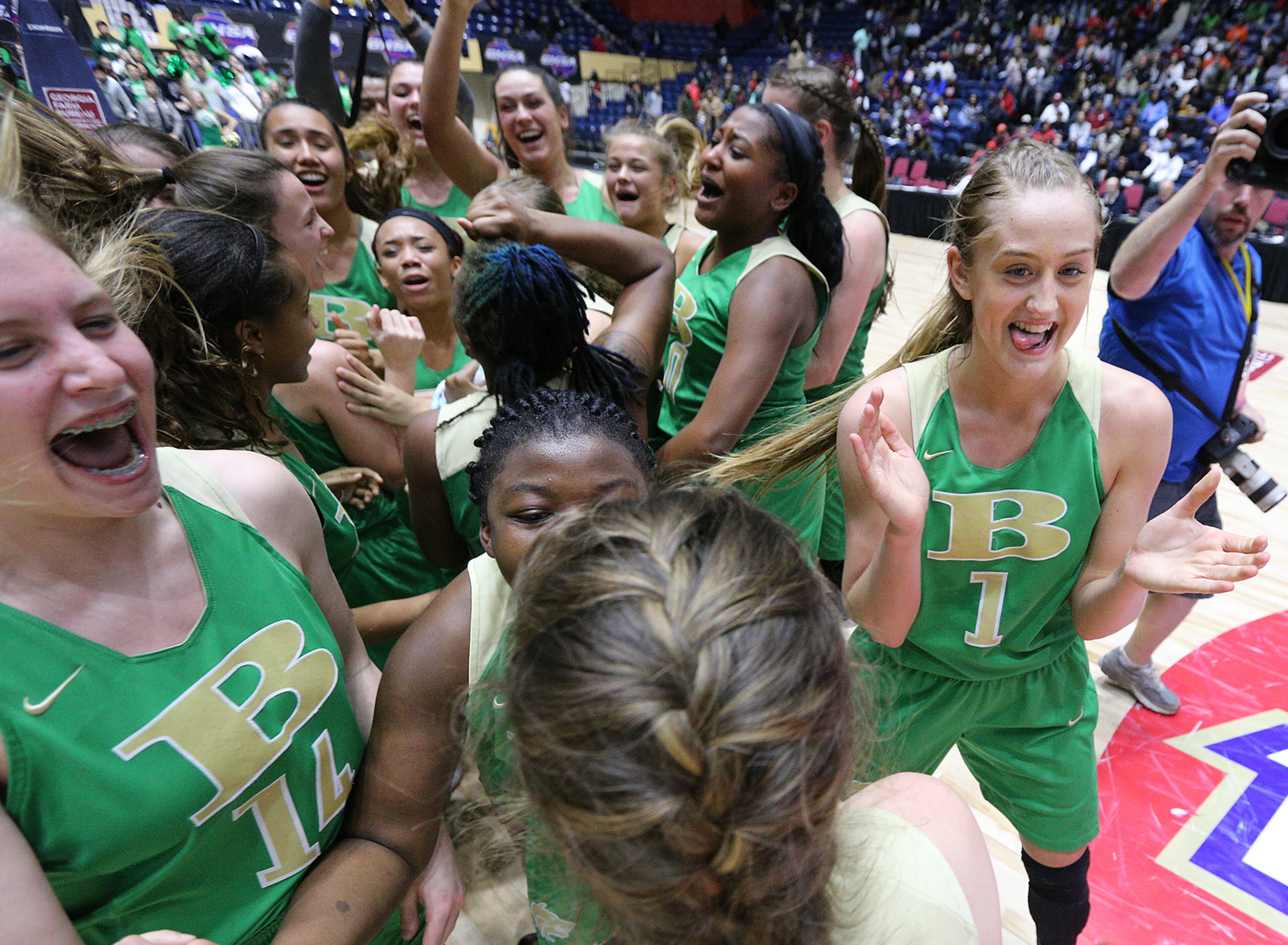 March 8, 2018 Macon: Buford guard Tory Ozment (right) and the Wolves celebrate beating Flowery Branch 60-49 in their GHSA state basketball championship game on Thursday, March 8, 2018, in Macon. Curtis Compton/ccompton@ajc.com