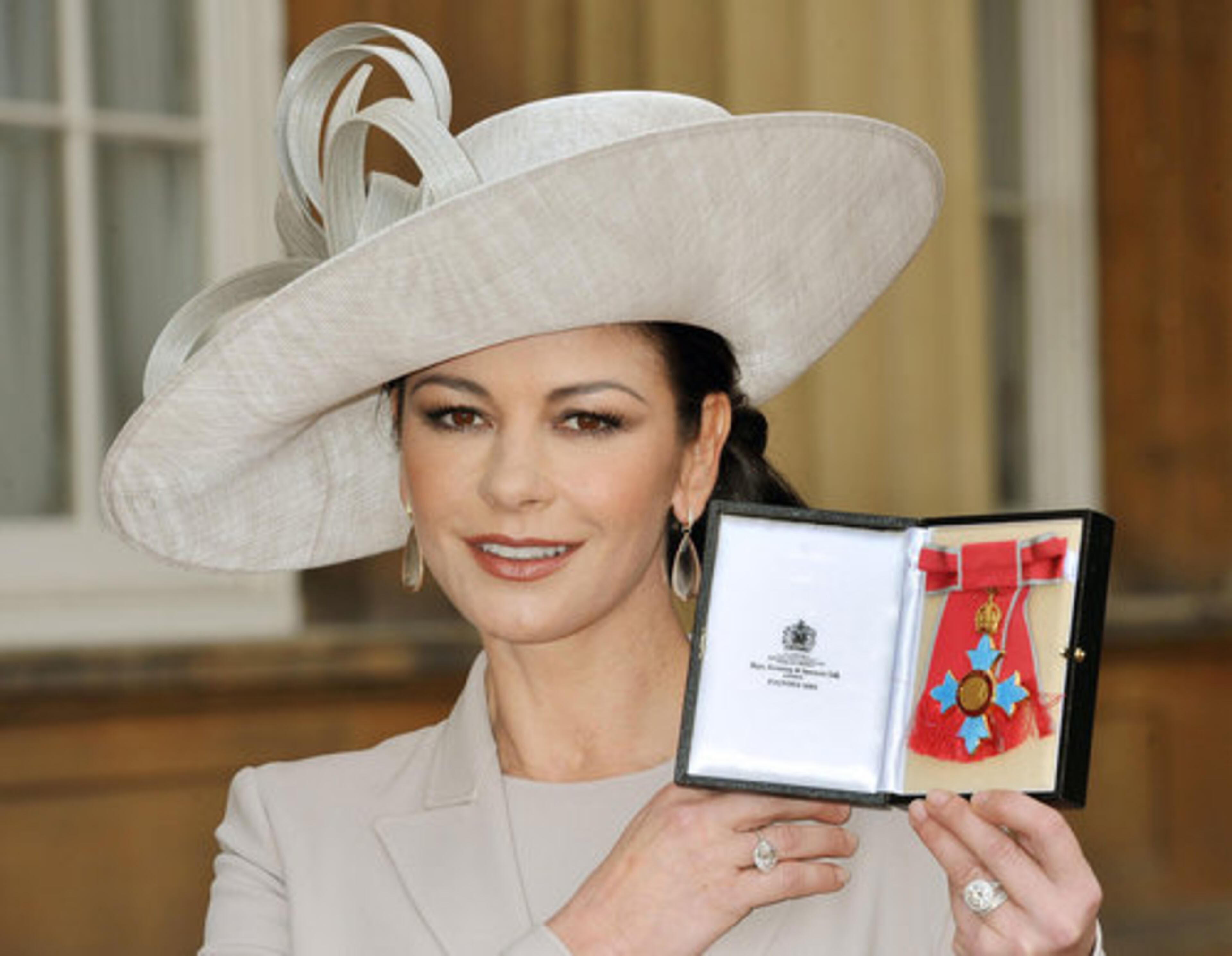 Actress Catherine Zeta Jones displays the insignia after she was made a Commander of the British Empire (CBE) by Britain's Prince Charles at Buckingham Palace in London, Thursday Feb. 24, 2011. The 41-year-old Welsh actress who became an Oscar-winning star received the honour for services to the film industry and to charity. The CBE is one step below Knight and Dame class in the order of chivalry. What other celebrities and notable figures have received this honor?