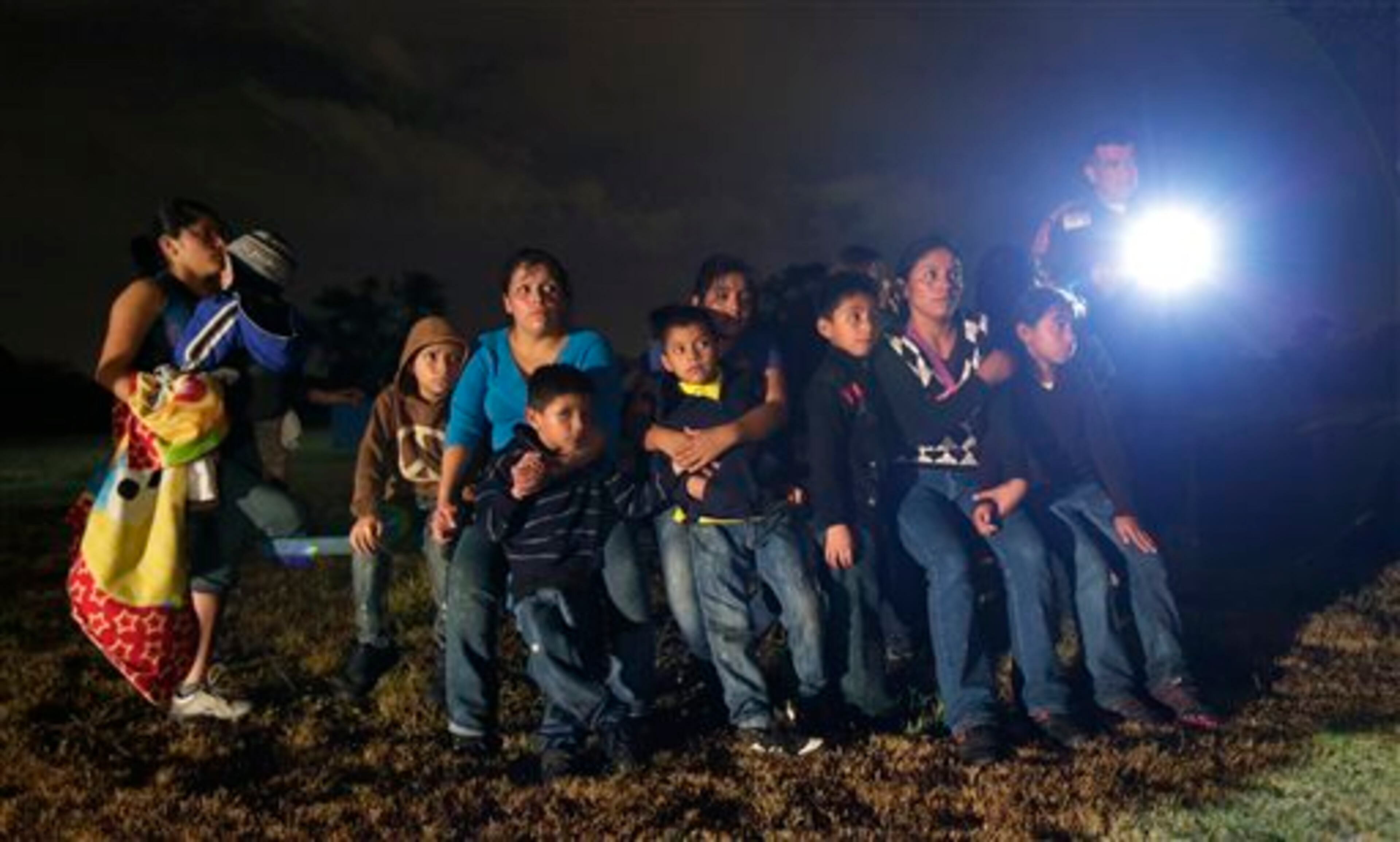 In this June 25, 2014 photo, a group of immigrants from Honduras and El Salvador who crossed the U.S.-Mexico border illegally are stopped in Granjeno, Texas. The epicenter of the recent surge in illegal immigration is a 5-mile slice of deep South Texas that has become a hot spot for migrants, human smugglers and drug cartels. (AP Photo/Eric Gay)