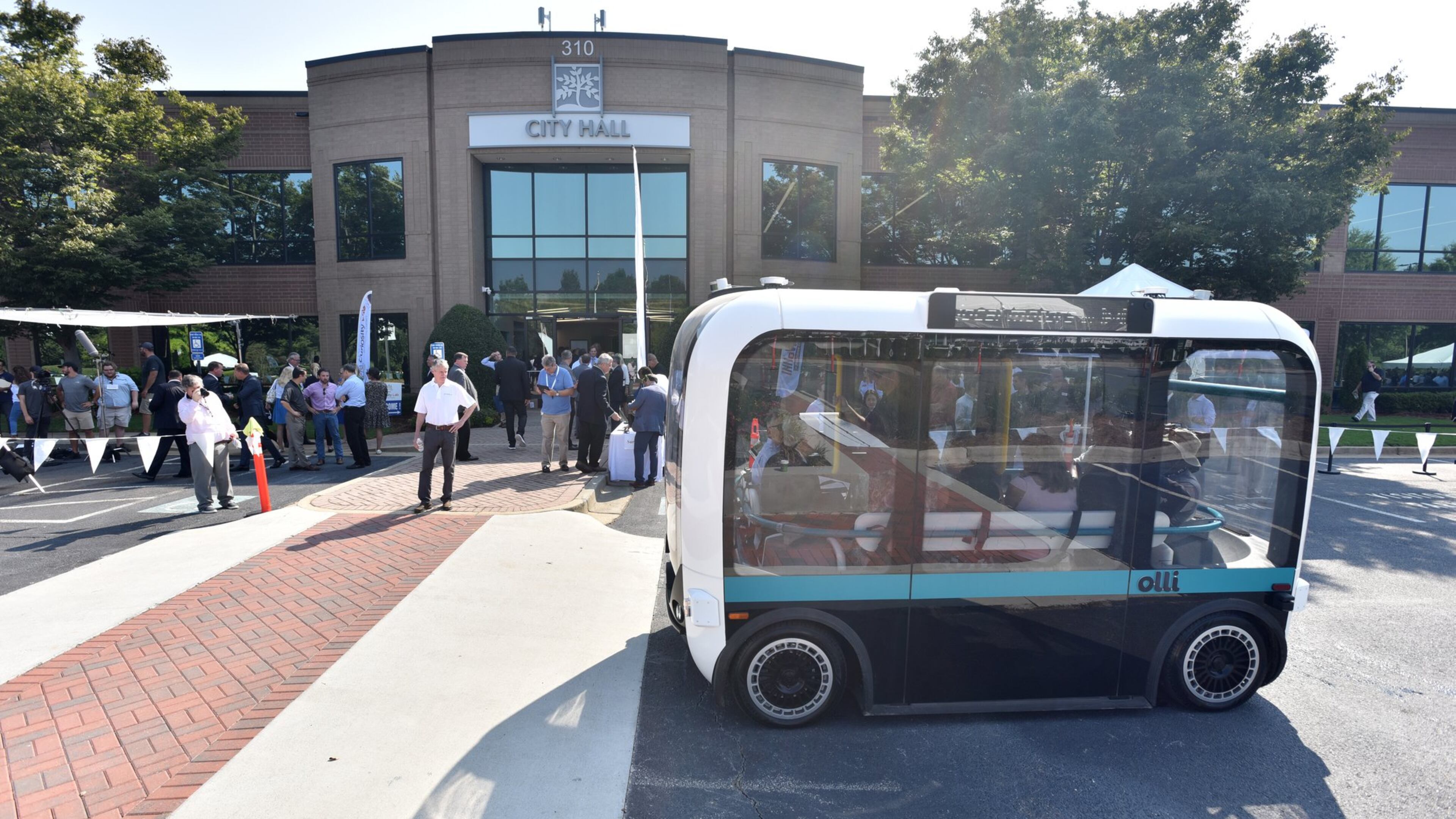 September 11, 2019 Peachtree Corners - Guests ride on Olli, self-driving electric shuttle, during the grand opening of Curiosity Lab at Peachtree Corners on Wednesday, September 11, 2019. Curiosity Lab is a publicly funded, real-world living laboratory and test bed featuring a one and a half mile autonomous vehicle test track within a 500 acre commercial office park. The Lab offers companies the opportunity to transition unique, innovative technologies from controlled environments into an active community. (Hyosub Shin / Hyosub.Shin@ajc.com)