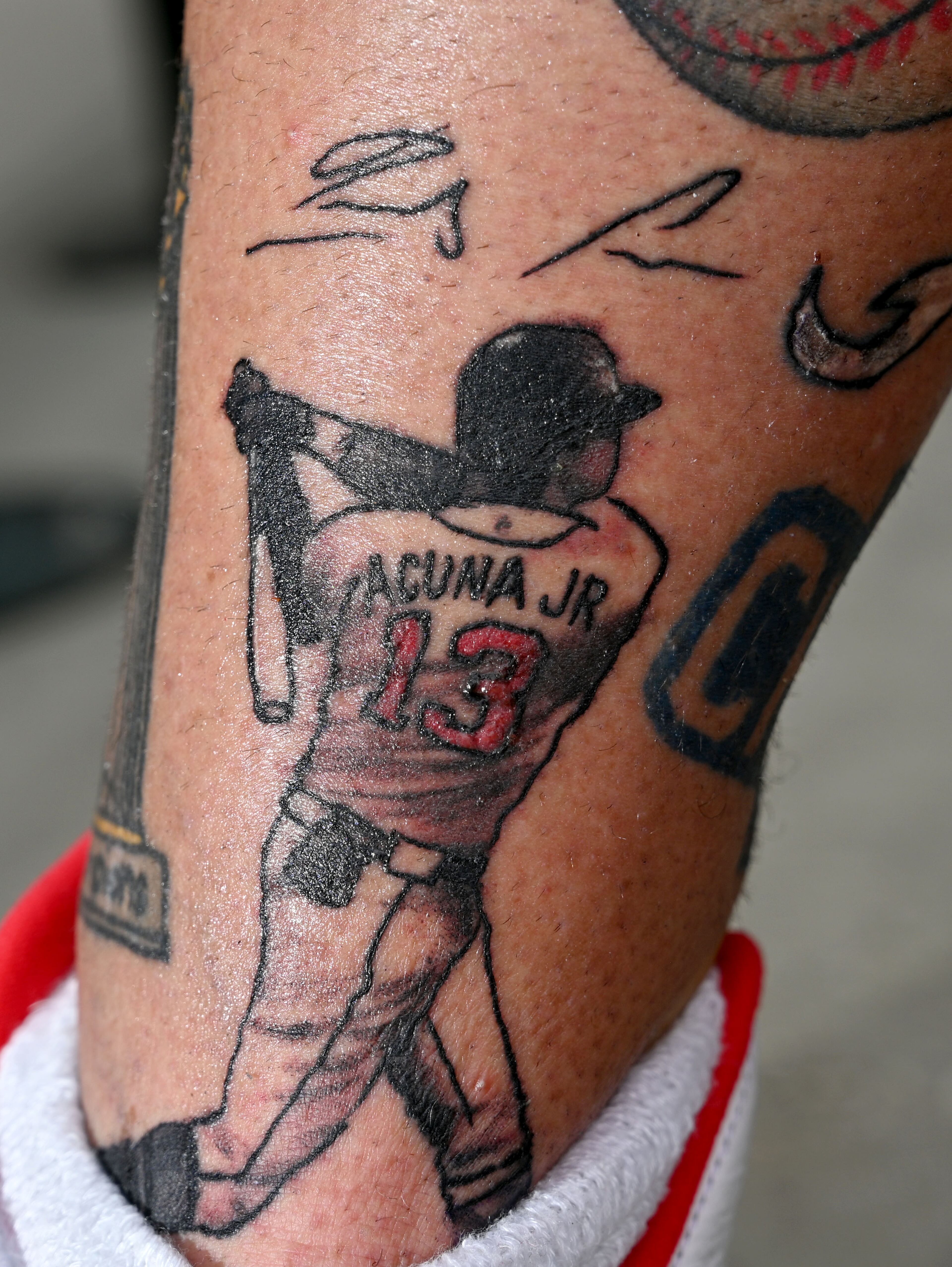 Steve Disney shows off his recent tattoo of Atlanta Braves' Ronald Acuna Jr. before Atlanta Braves home game against St. Louis Cardinals at Truist Park, Wednesday, September 6, 2023, in Atlanta. (Hyosub Shin / Hyosub.Shin@ajc.com)