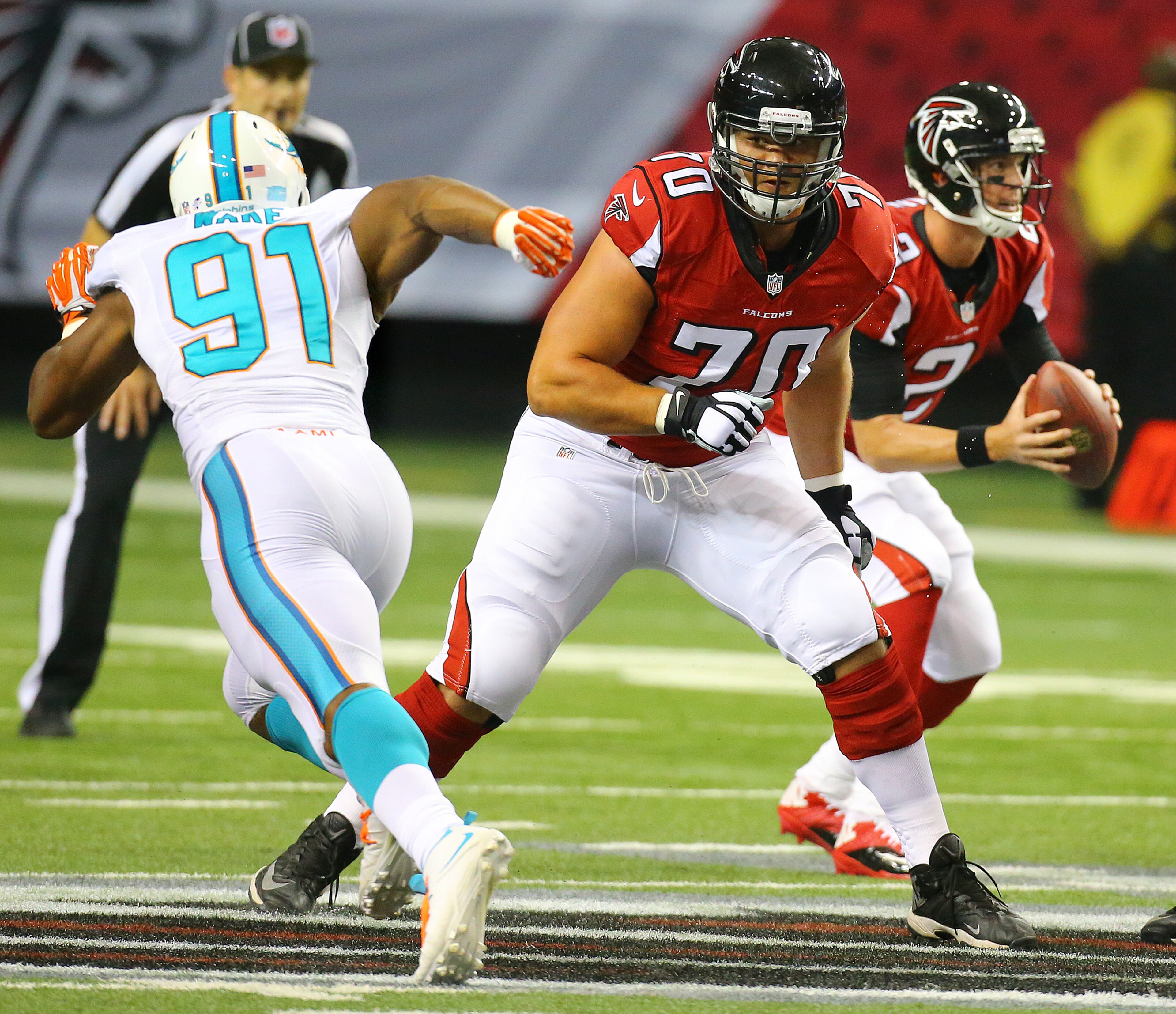 Falcons rookie offensive lineman Jake Matthews looks to block Miami defensive end Cameron Wake as quarterback Matt Ryan looks to pass during their NFL exhibition game on Friday, August 8, 2014, in Atlanta.
