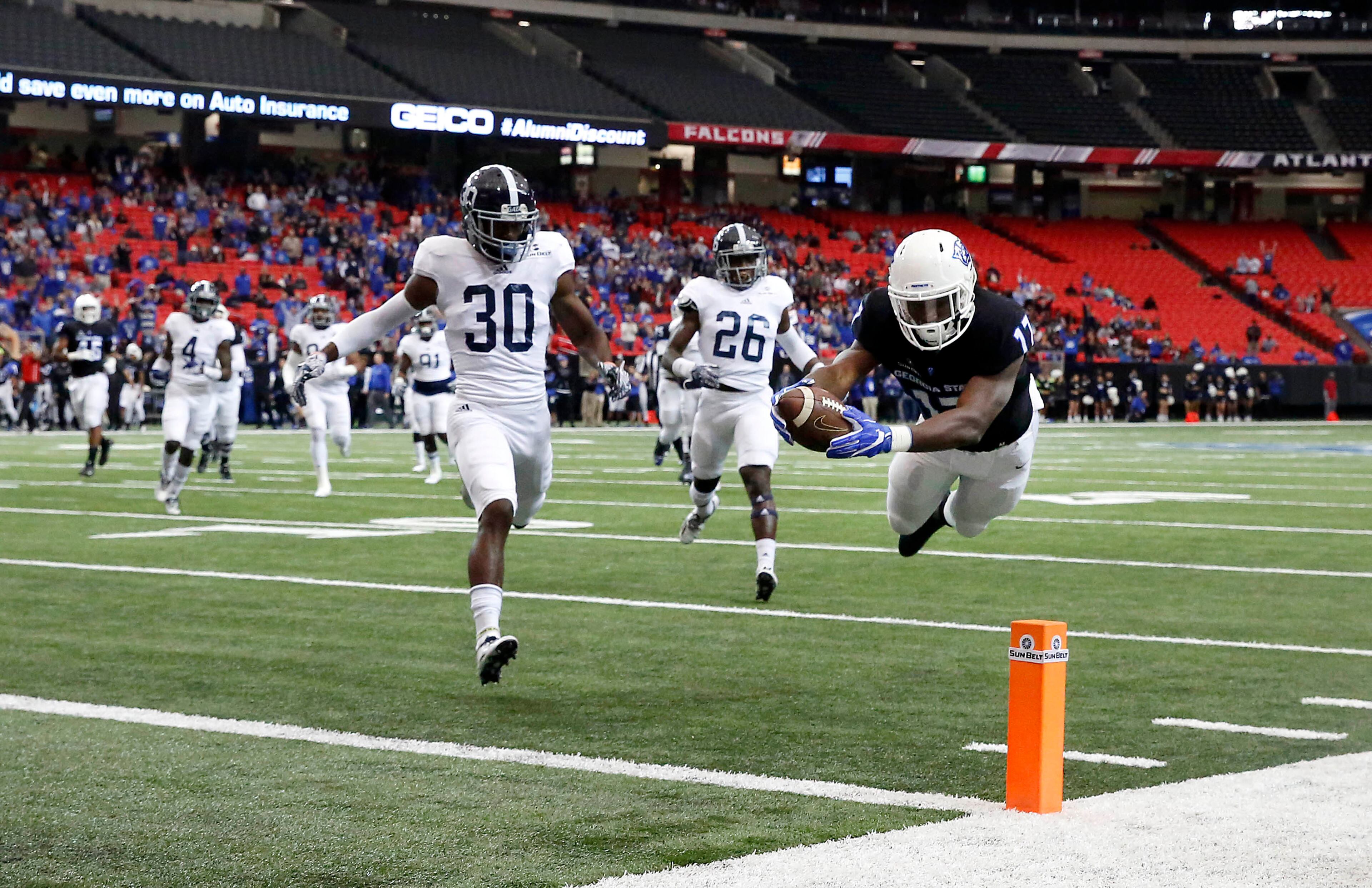 November 19, 2016 - Atlanta, Ga: Georgia State Panthers running back Glenn Smith (17) dives to score a touchdown against Georgia Southern Eagles cornerback Jessie Liptrot (30) and safety Jay Bowdry (26) in the first half of their game at the Georgia Dome Saturday November 19, 2016, in Atlanta, Ga. PHOTO / JASON GETZ