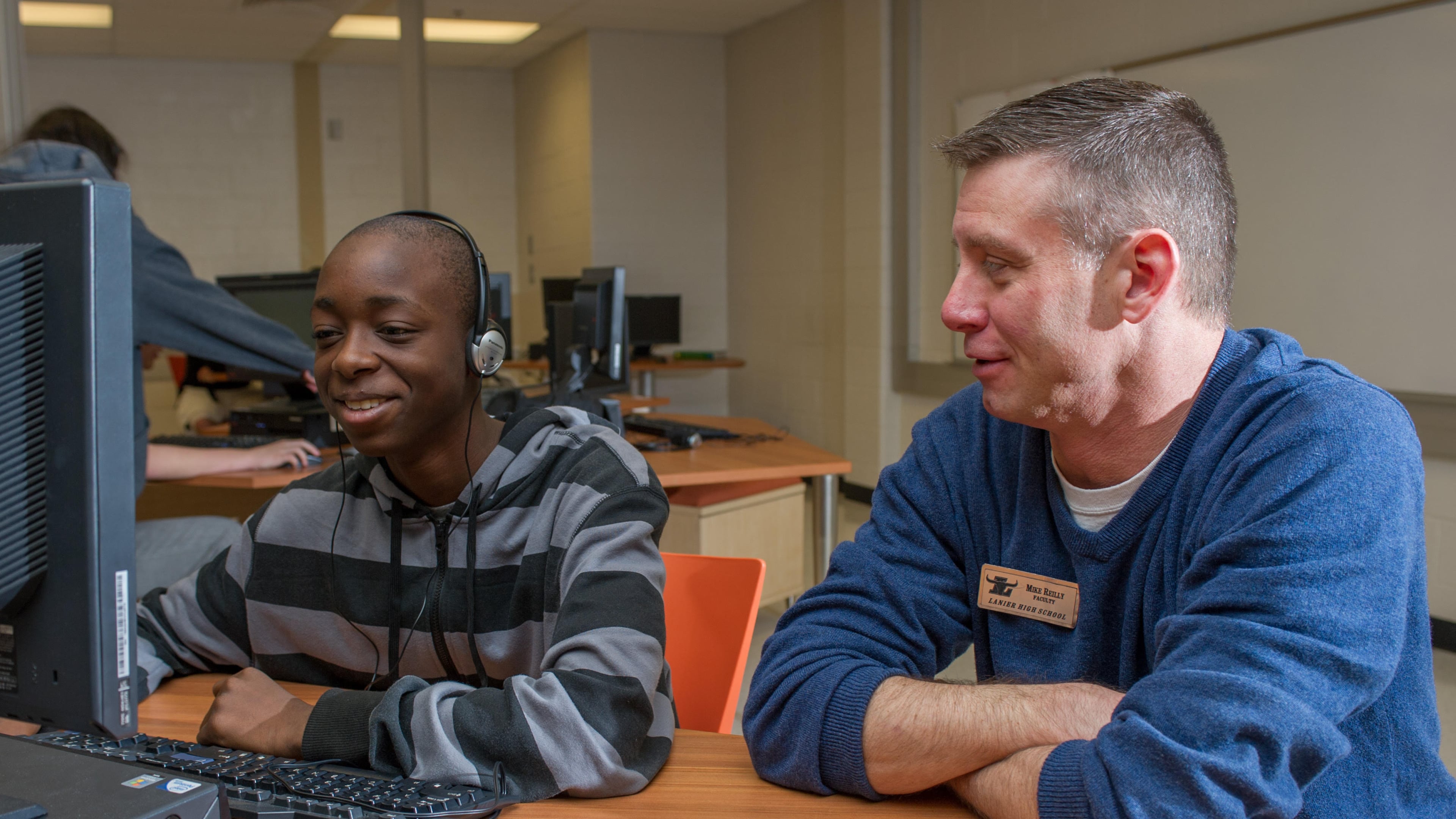 Mike Riley (right), a technology teacher at Lanier High in Sugar Hill, piloted the EarSketch program that teaches students to compose original music through coding. Contributed.
