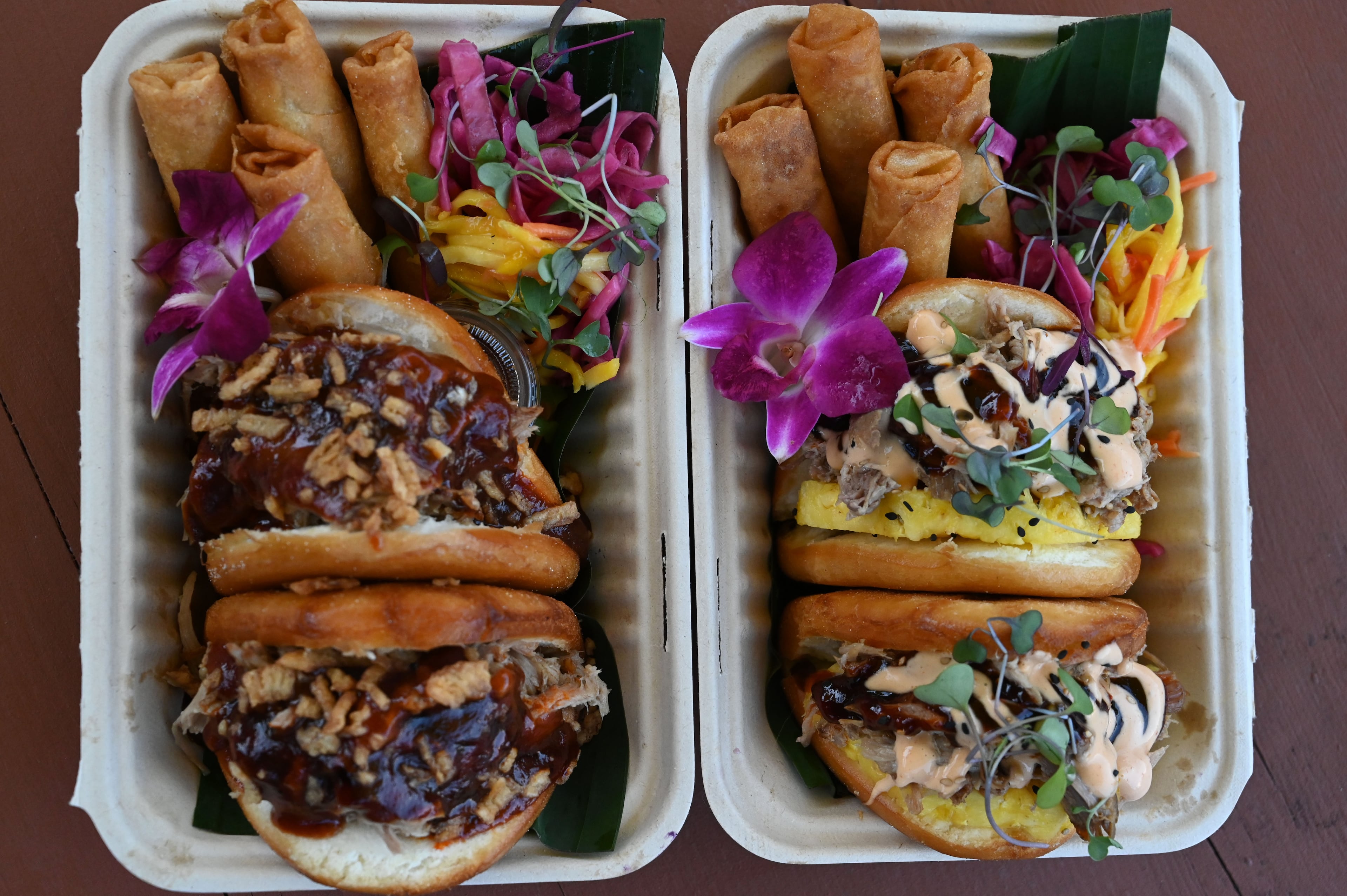 Kalua pork bao buns (left) and pineapple buns (right) prepared by Sara Siv and Jess Gorsuch, owners of Hapa Kitchen, at Block & Drum in Chamblee on Wednesday, June 17, 2026. (Hyosub Shin/AJC)
