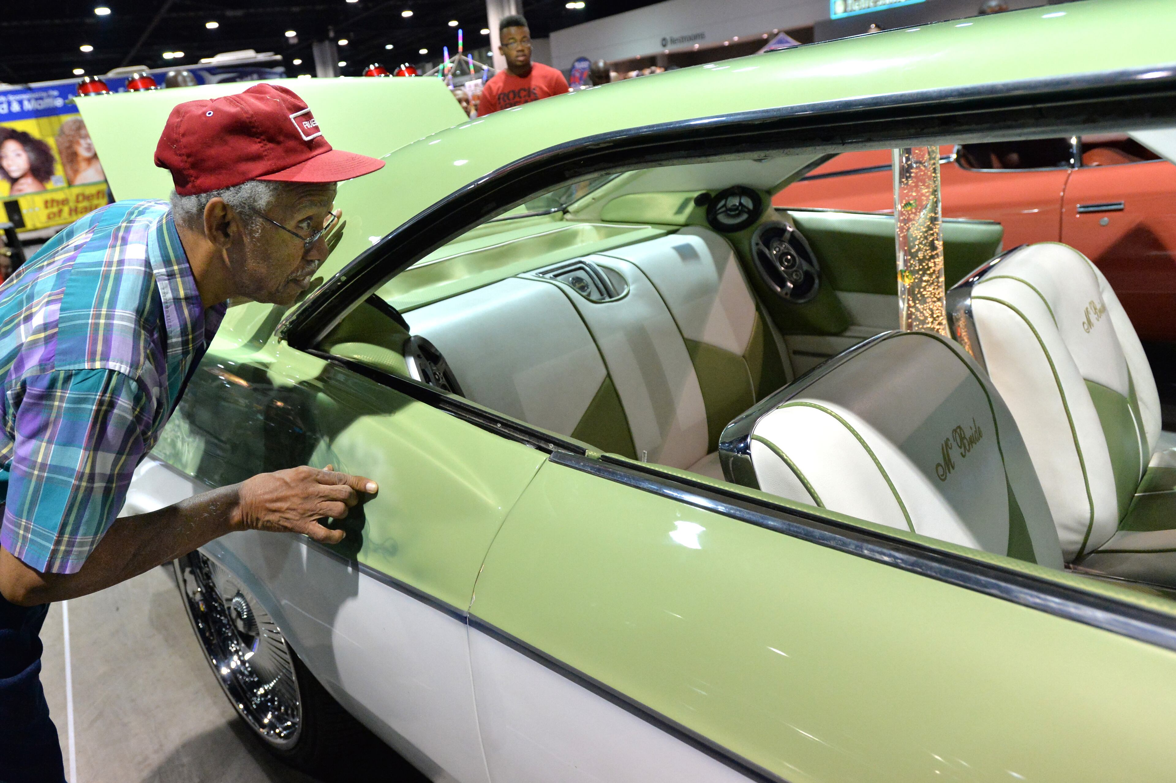Sam Edwards, of Austell, takes a look inside of a custom vehicle during the V-103/WAOK 10th Annual Car & Bike Show at the Georgia World Congress Center on Saturday, June 22, 2013.