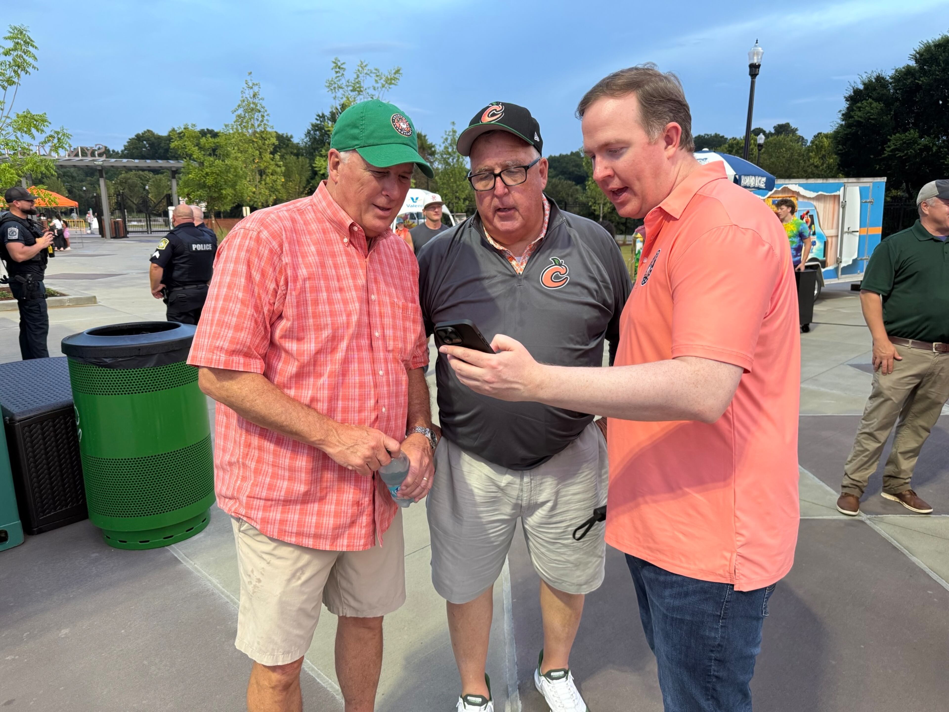 Columbus Mayor Skip Henderson (from left), veteran reporter Chuck Williams and U.S. Rep. Brian Jack chat about the Clingstones' record at Synovus Park on Friday. (Greg Bluestein/AJC)