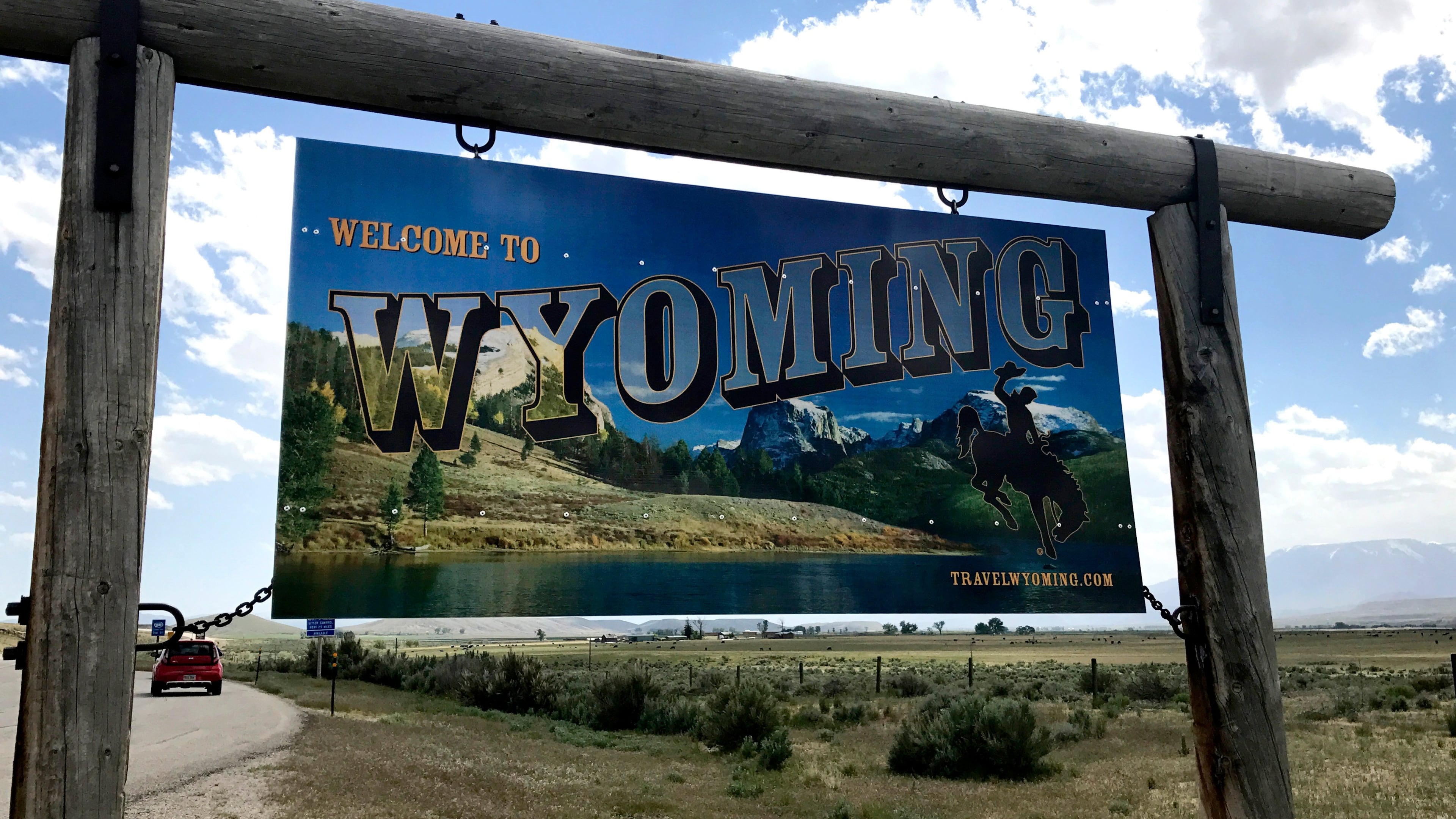 FILE - A sign on the border of Wyoming and Montana appears on the side of Belfry Highway, May 24, 2017, in Powell, Wyoming. (AP Photo/Robert Yoon, File)