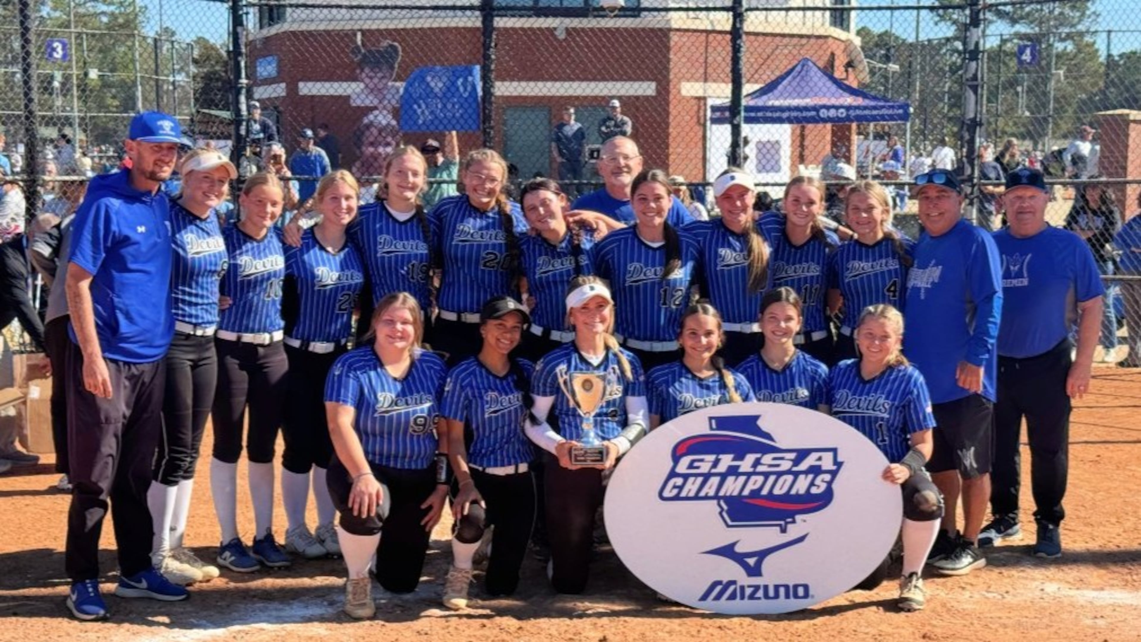 Bremen coaches and players celebrate with the trophy after winning the Class A Division I fast-pitch softball championship on Nov. 1, 2025, in Columbus. (Courtesy of Georgia High School Association)