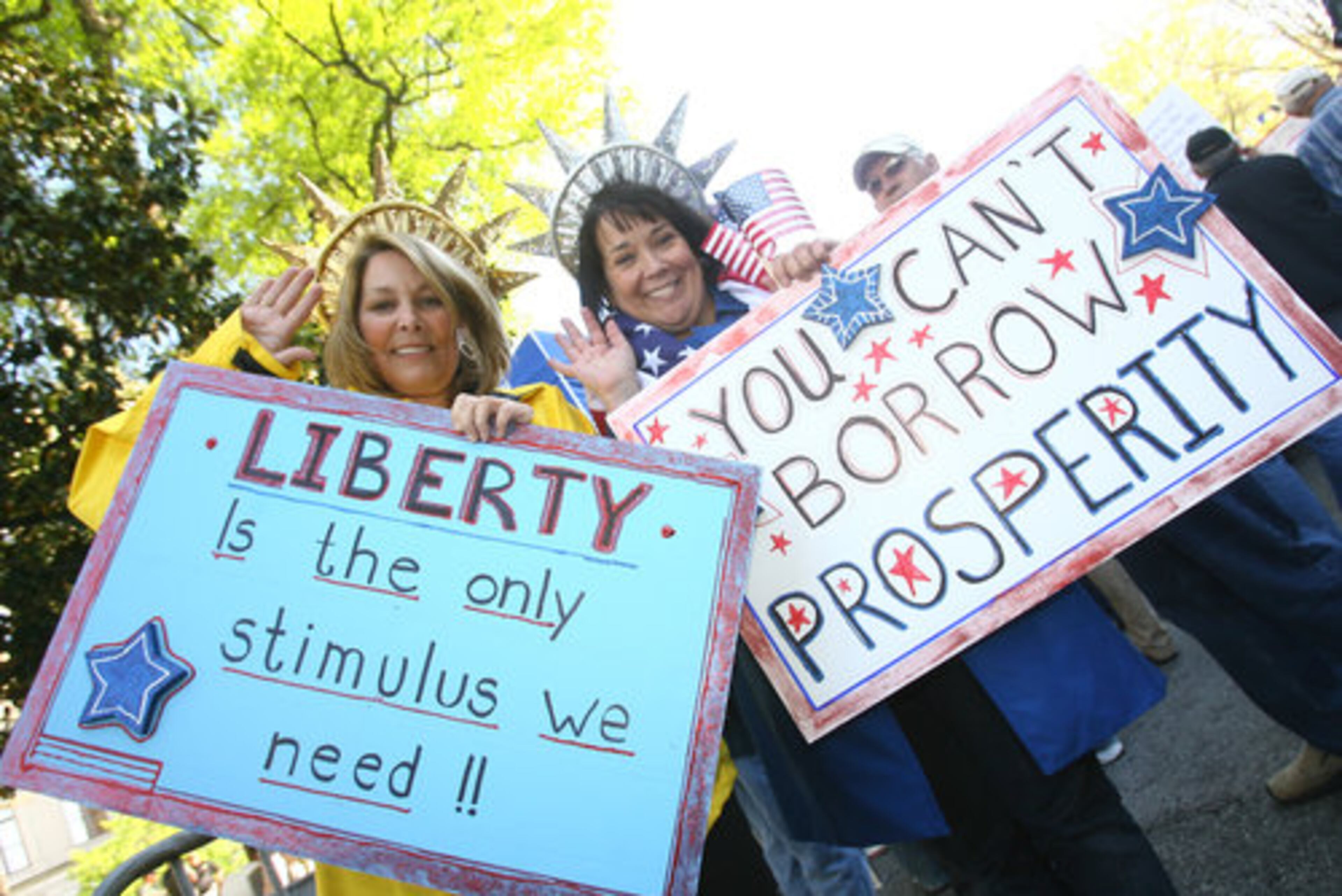 Kathleen O'Neil (left) and Donna Strand, who are neighbors in Smyrna, came to the Atlanta Tax Day Tea Party in Lady Liberty tiaras.