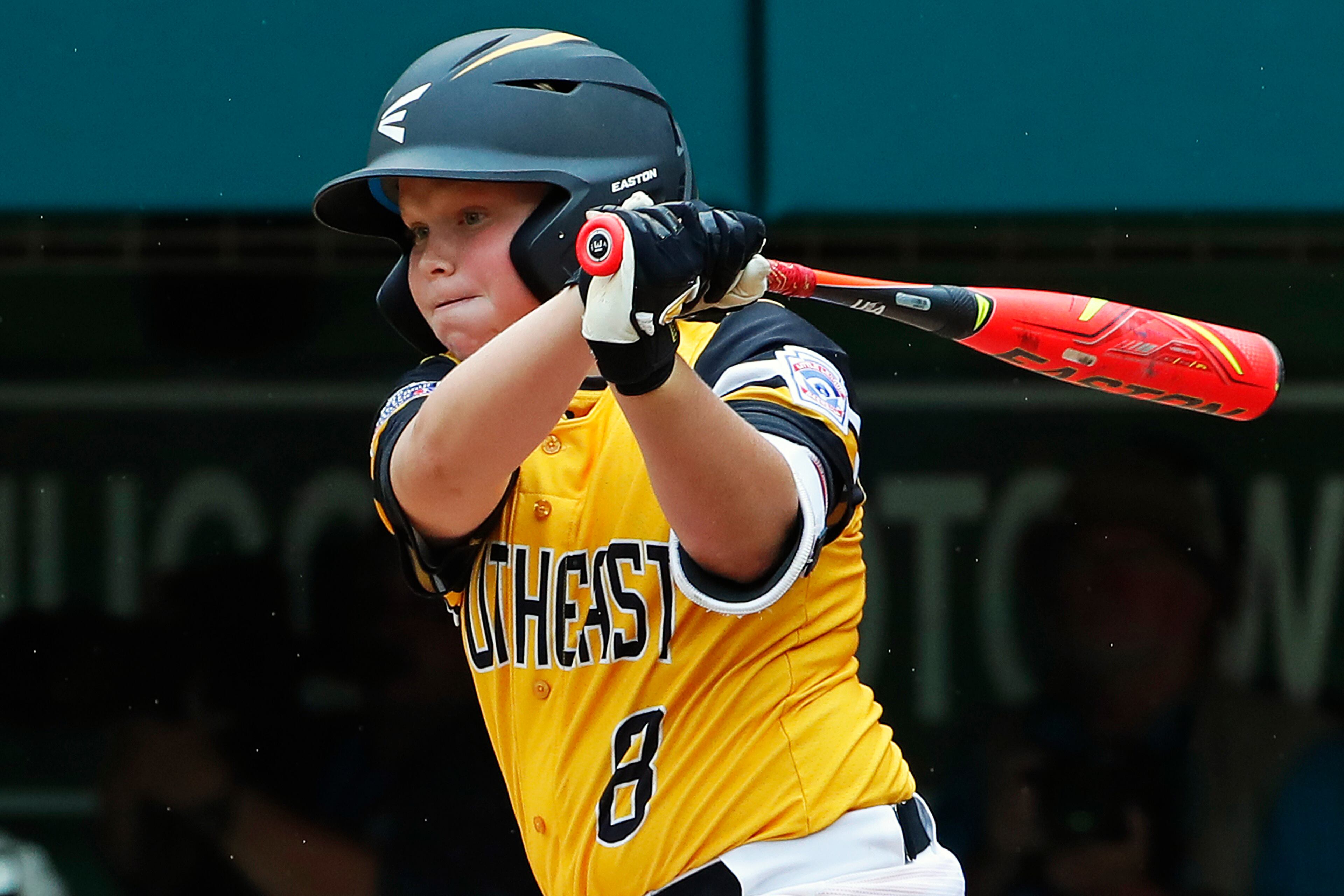 Peachtree City, Georgia's Jack Ryan drives in two runs with a single off Grosse Pointe Woods, Michigan's Brennan Hill (19) in the first inning of an elimination baseball game in United States pool play at the Little League World Series tournament in South Williamsport, Pa., Wednesday, Aug. 22, 2018. (AP Photo/Gene J. Puskar)