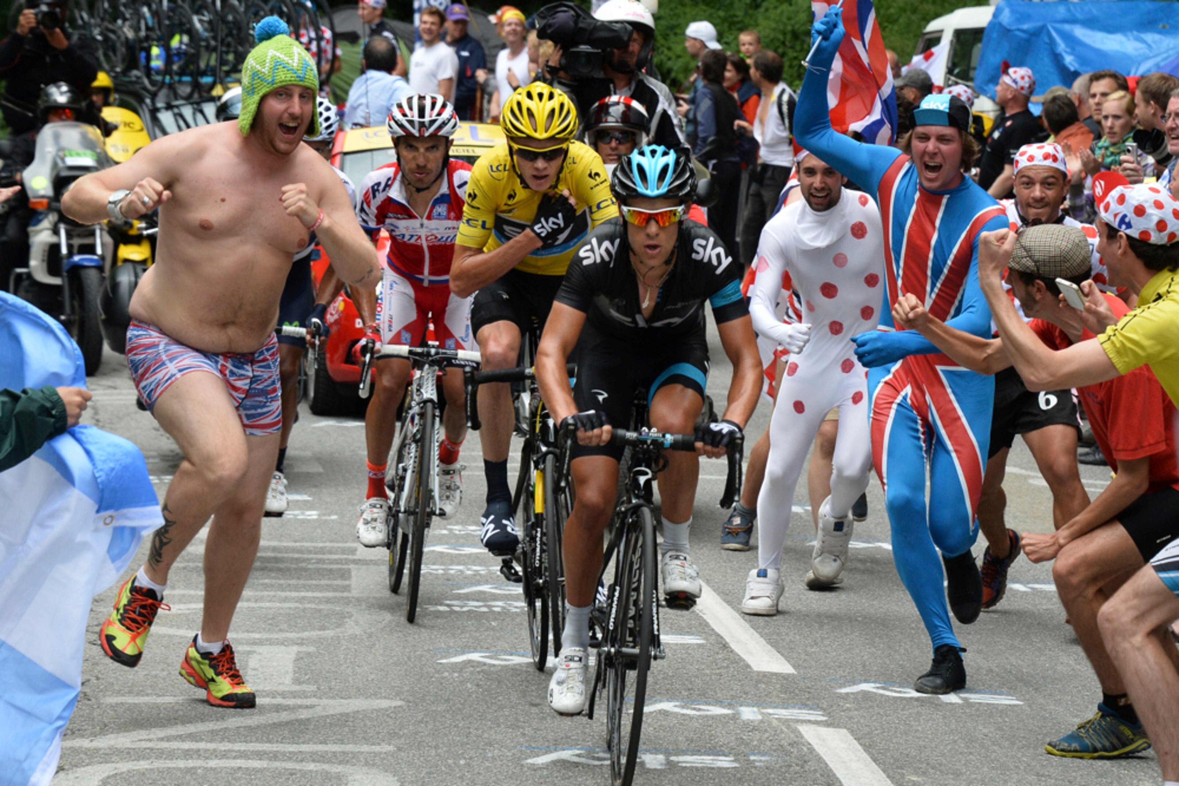 PHOTO BUMMED--Spectators with the British flag run alongside Richie Porte of Australia, Christopher Froome of Britain, wearing the overall leader's yellow jersey, and Joaquim Rodriguez of Spain as they climb towards Alpe-d'Huez pass during the eighteenth stage of the Tour de France cycling race over 172.5 kilometers (107.8 miles) with start in Gap and finish in Alpe-d'Huez, France, Thursday July 18, 2013. (AP Photo/Bernard Papon, Pool)