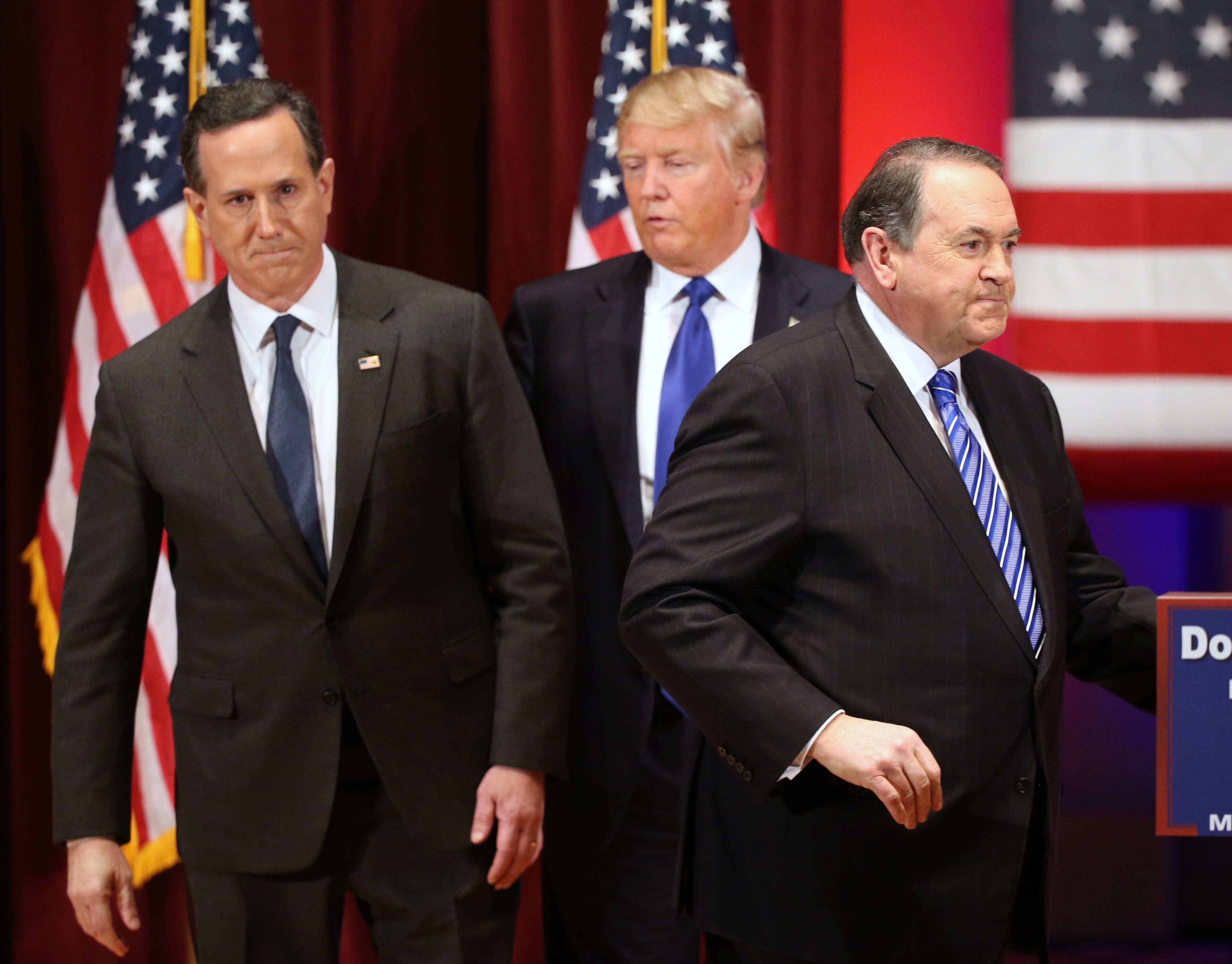 Republican presidential candidate Donald Trump appears on stage with fellow candidate Rick Santorum, left, and Mike Huckabee, at a Trump event in support of veterans at Drake University in Des Moines, Iowa, Thursday, Jan. 28, 2016. (AP Photo/Andrew Harnik)