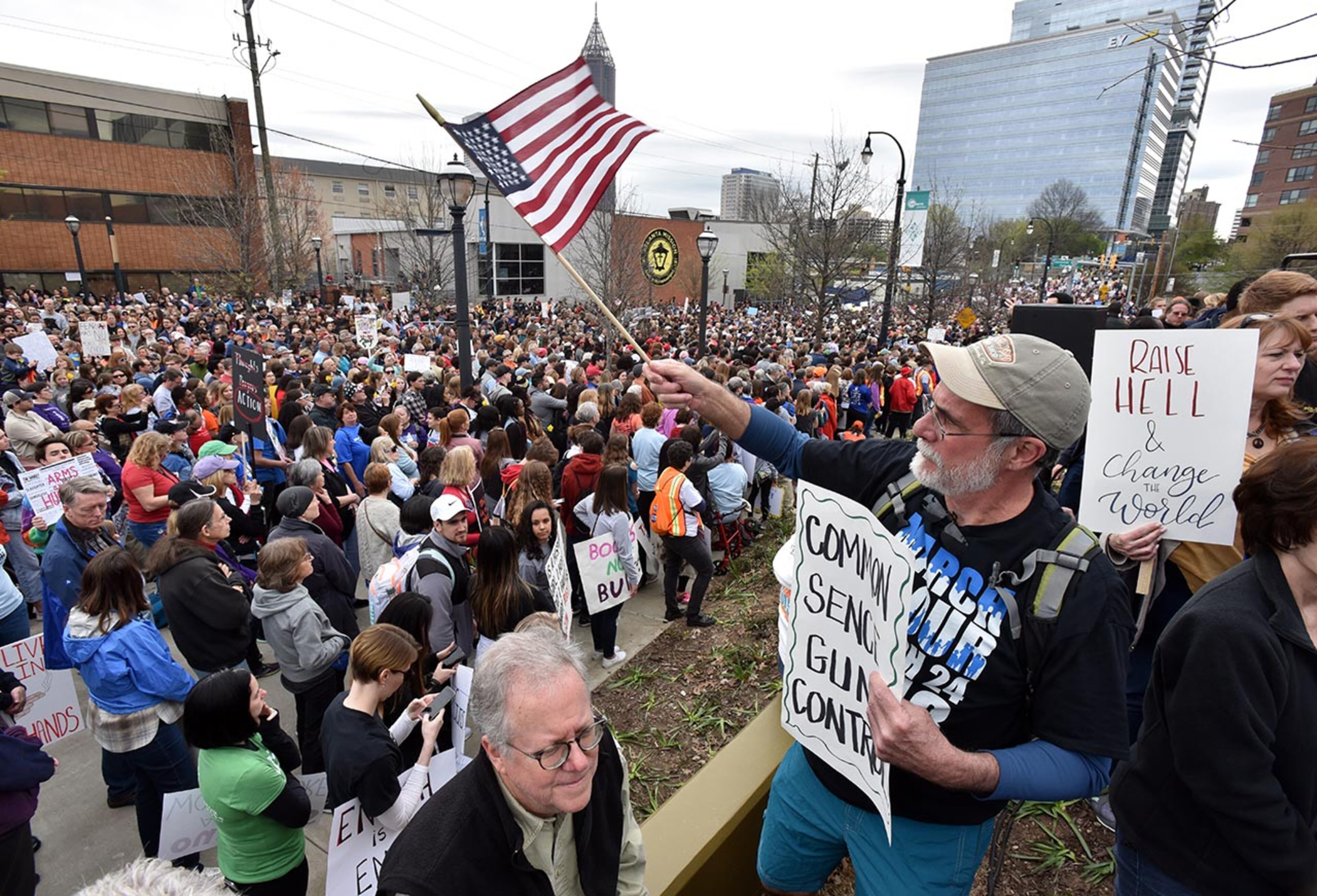 March 24, 2018 Atlanta - Ron Mercure waves an American flag as people gather to participate in the March For Our Lives rally at the Center for Civil and Human Rights before walking to Liberty Plaza on Saturday, March 24, 2018. Atlanta police estimated the crowd at near 30,000 for todayâÃôs March for Our Lives. People of all ages were drawn to one of the nationwide demonstrations in a movement begun by student survivors of last monthâÃôs mass killing in a Parkland, Fla., school. Some of those Florida students were among the speakers in Atlanta. HYOSUB SHIN / HSHIN@AJC.COM