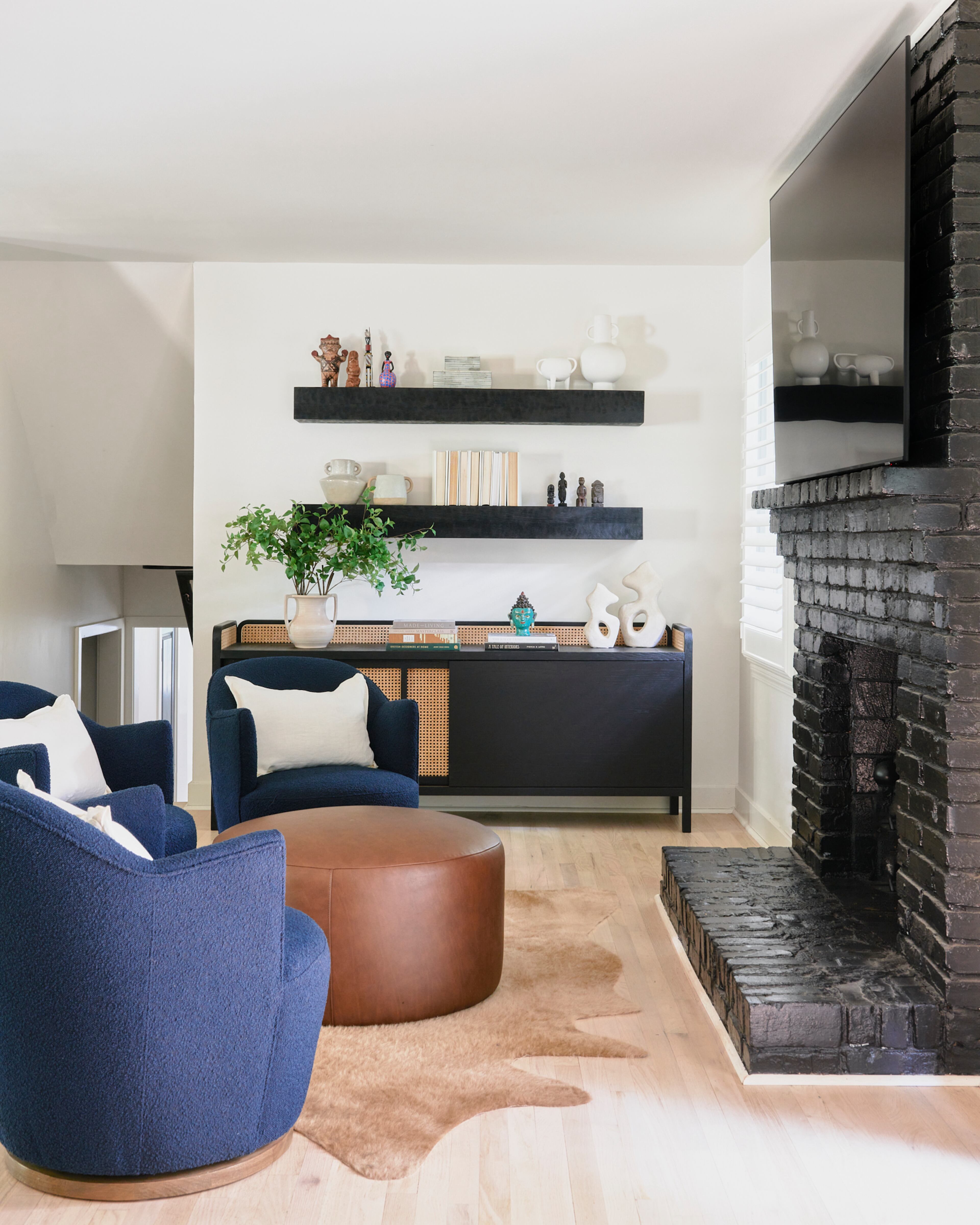 Dramatic black salvaged mantels work with smaller collectibles — bought on the homeowners' travels — here because of the striking contrast of large and small scales, designer Andi Morse says.
(Courtesy of Morse Design / Elliot Fuerniss Photography)