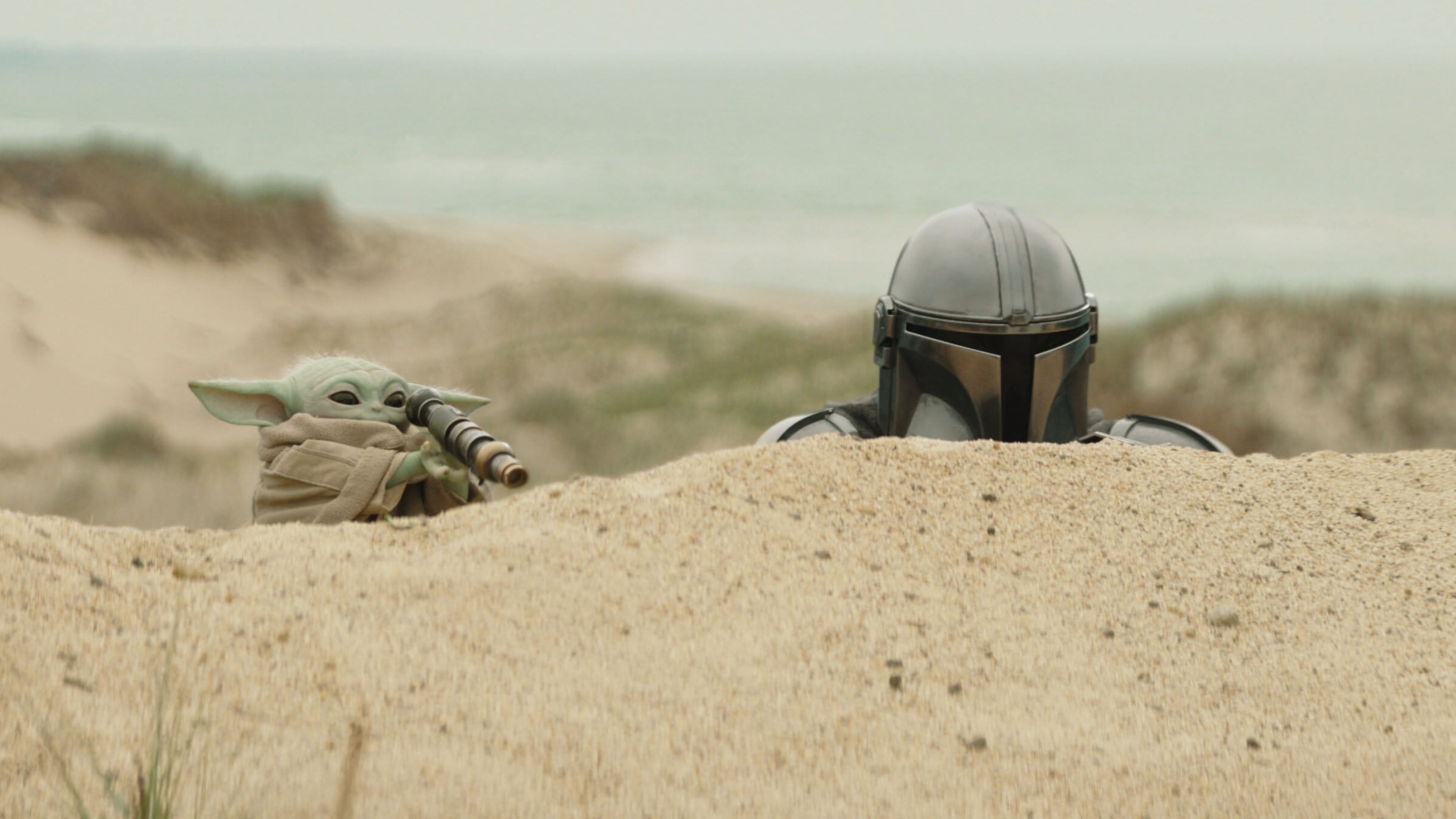 This image released by Disney shows The Mandalorian, portrayed by Pedro Pascal, right, and Grogu in a scene from Lucasfilm's "Star Wars: The Mandalorian and Grogu." (Lucasfilm Ltd. - Disney via AP)