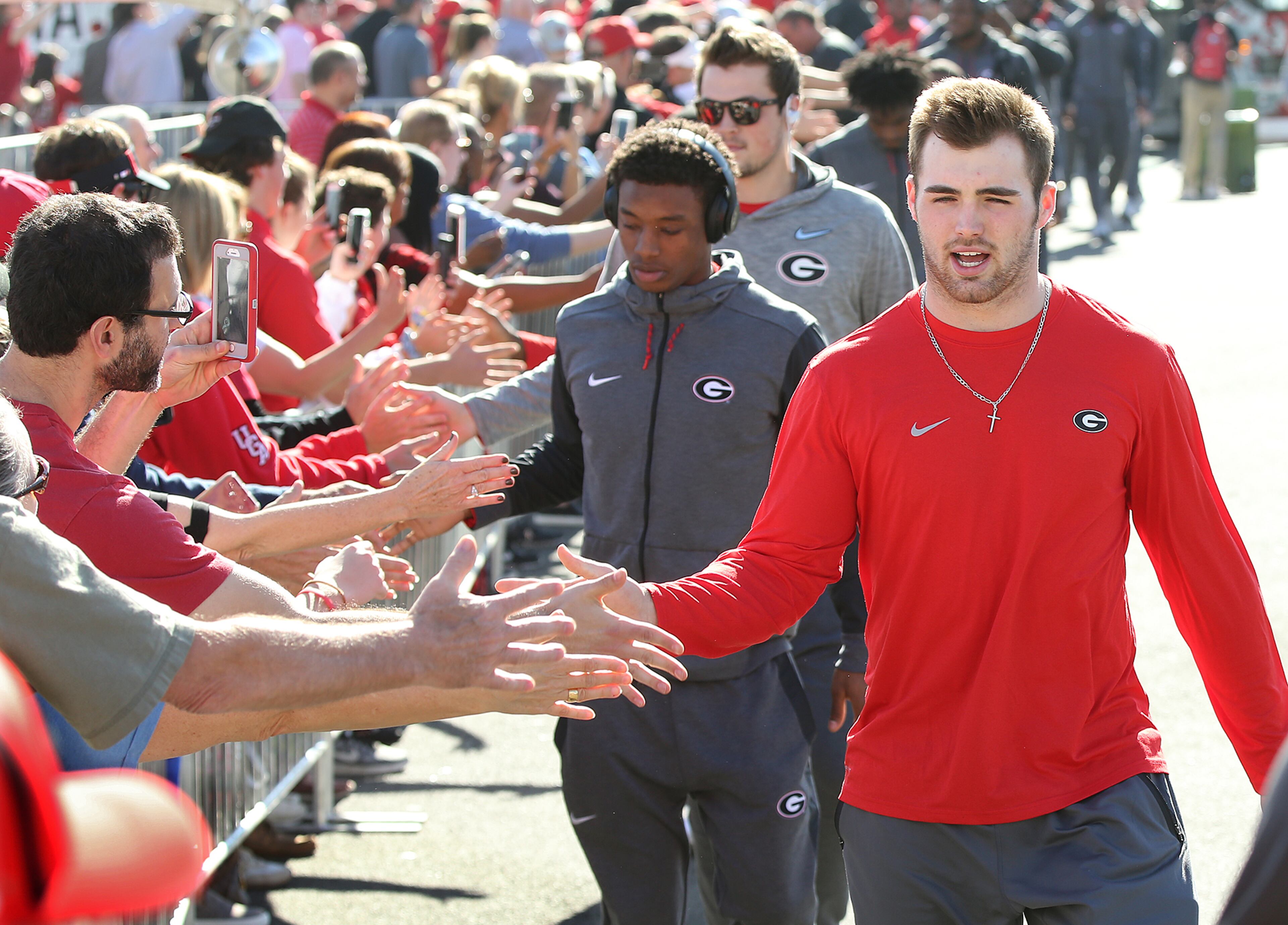 December 31, 2017 Pasadena: Georgia quarterback Jake Fromm gives fans five while arriving for the team photo at Rose Bowl Stadium on Sunday, December 31, 2017, in Pasadena. Curtis Compton/ccompton@ajc.com