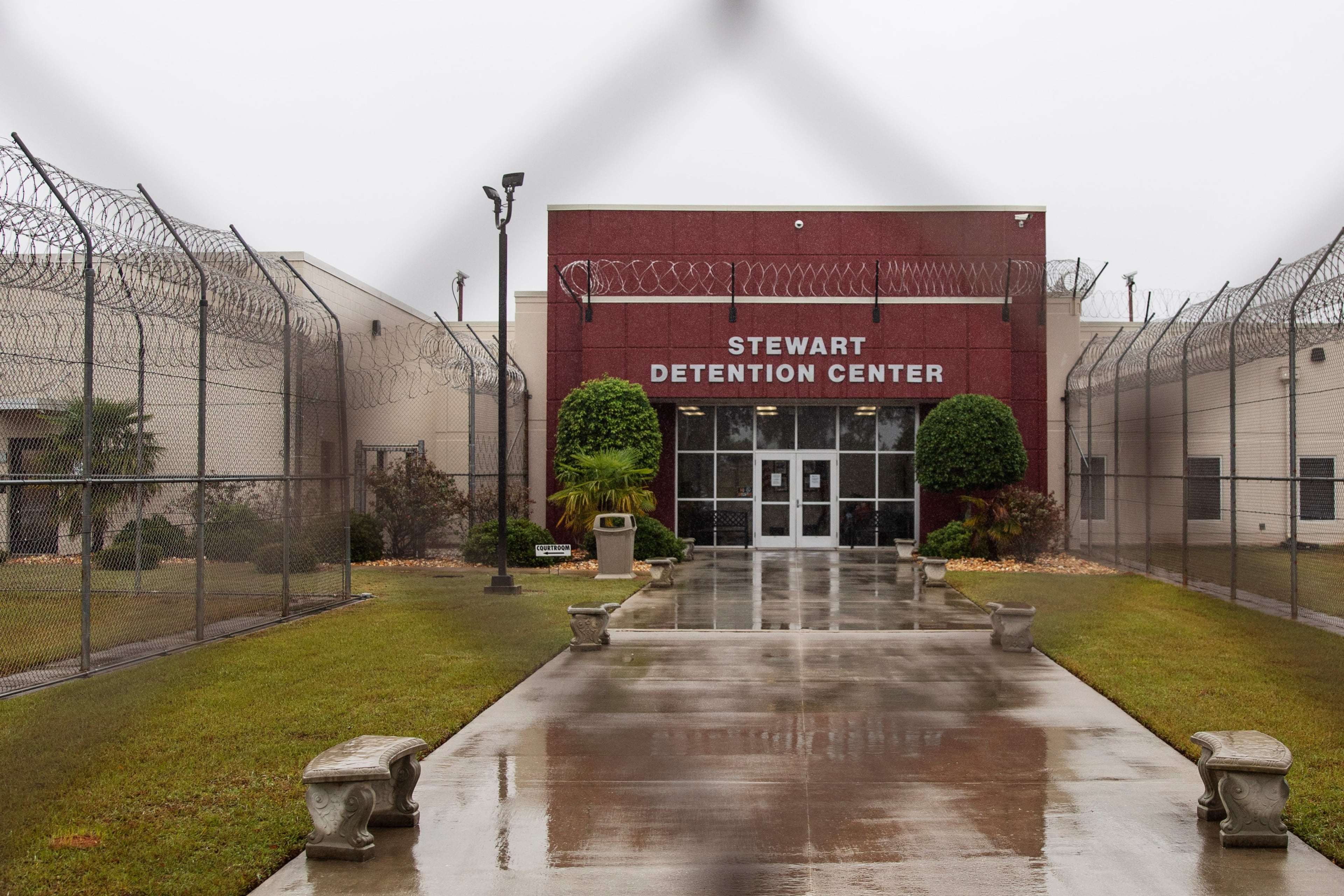 The Stewart Detention Center is seen through the front gate, Friday, Nov. 15, 2019, in Lumpkin, Ga. The rural town is about 140 miles southwest of Atlanta and next to the Georgia-Alabama state line. The town’s 1,172 residents are outnumbered by the roughly 1,650 male detainees that U.S. Immigration and Customs Enforcement said were being held in the detention center in late November. (David Goldman/AP)