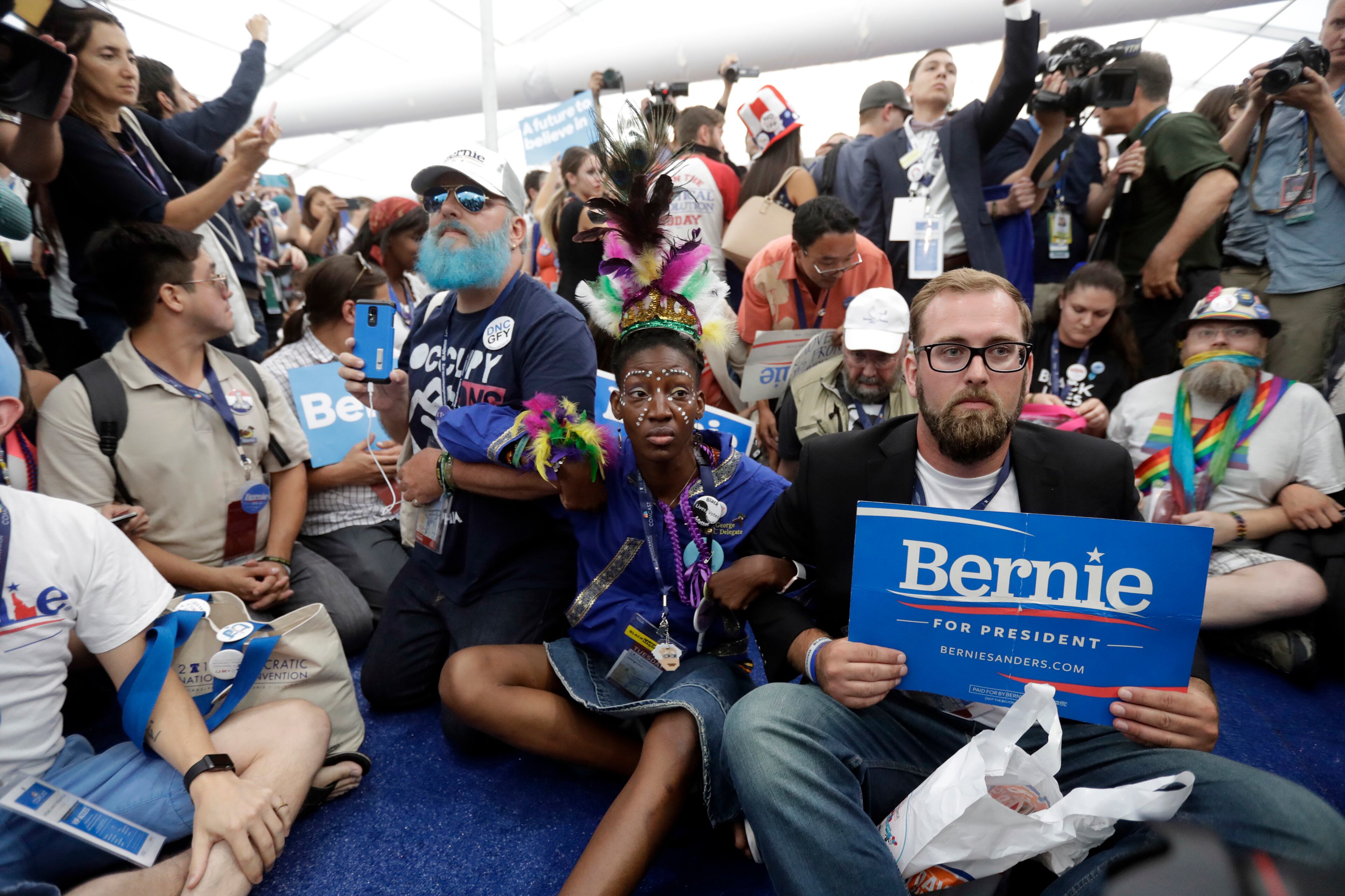 Delegates protest in the media filing center as they walk out of the convention floor during the second day session of the Democratic National Convention in Philadelphia, Tuesday, July 26, 2016. (AP Photo/Matt Rourke)