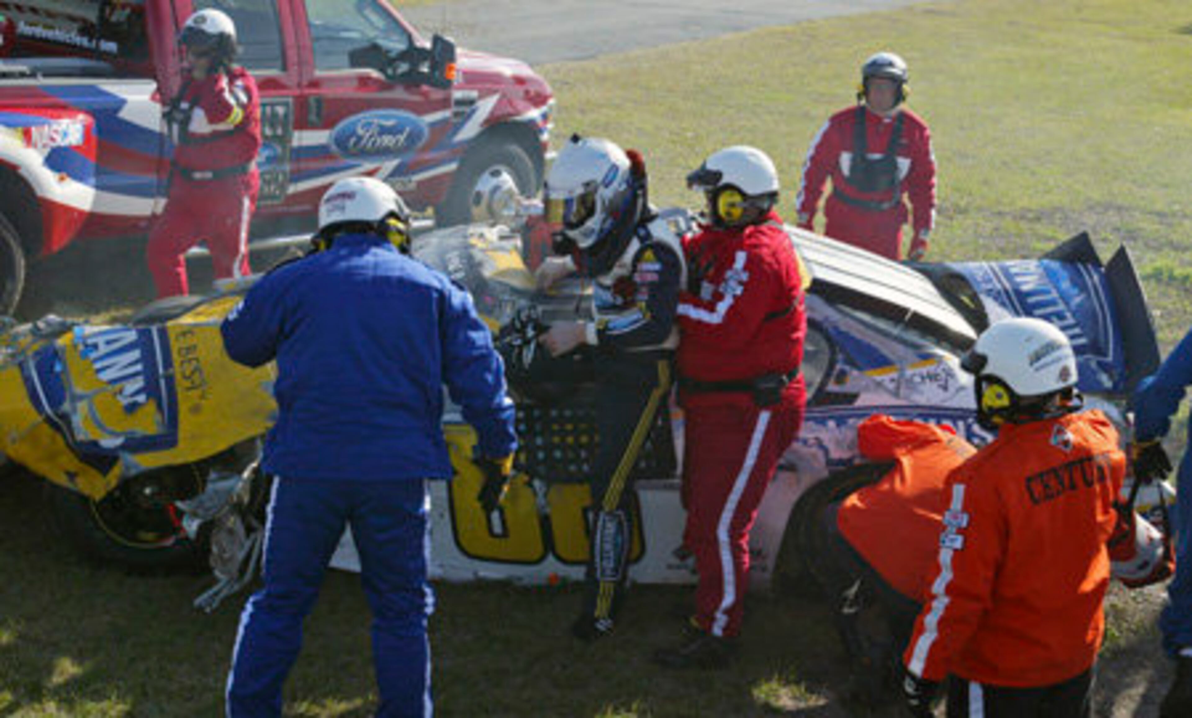 Emergency personnel help Dale Earnhardt Jr from his car after a crash.