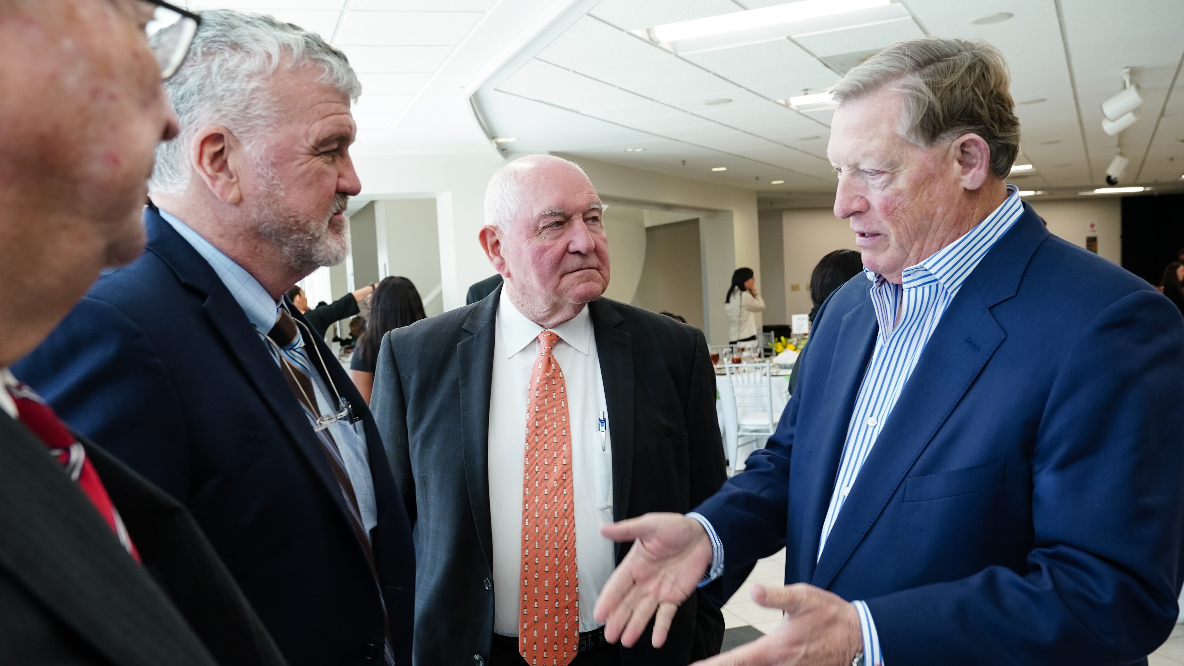 University System of Georgia Chancellor Sonny Perdue, center, is seen during a luncheon following the investiture ceremony for Georgia Gwinnett College President Jann L. Joseph, on April 1, 2022, in Lawrenceville. The college is one of several schools that have asked for more money for construction projects, citing rising costs for materials. (Elijah Nouvelage/Special to the Atlanta Journal-Constitution)
