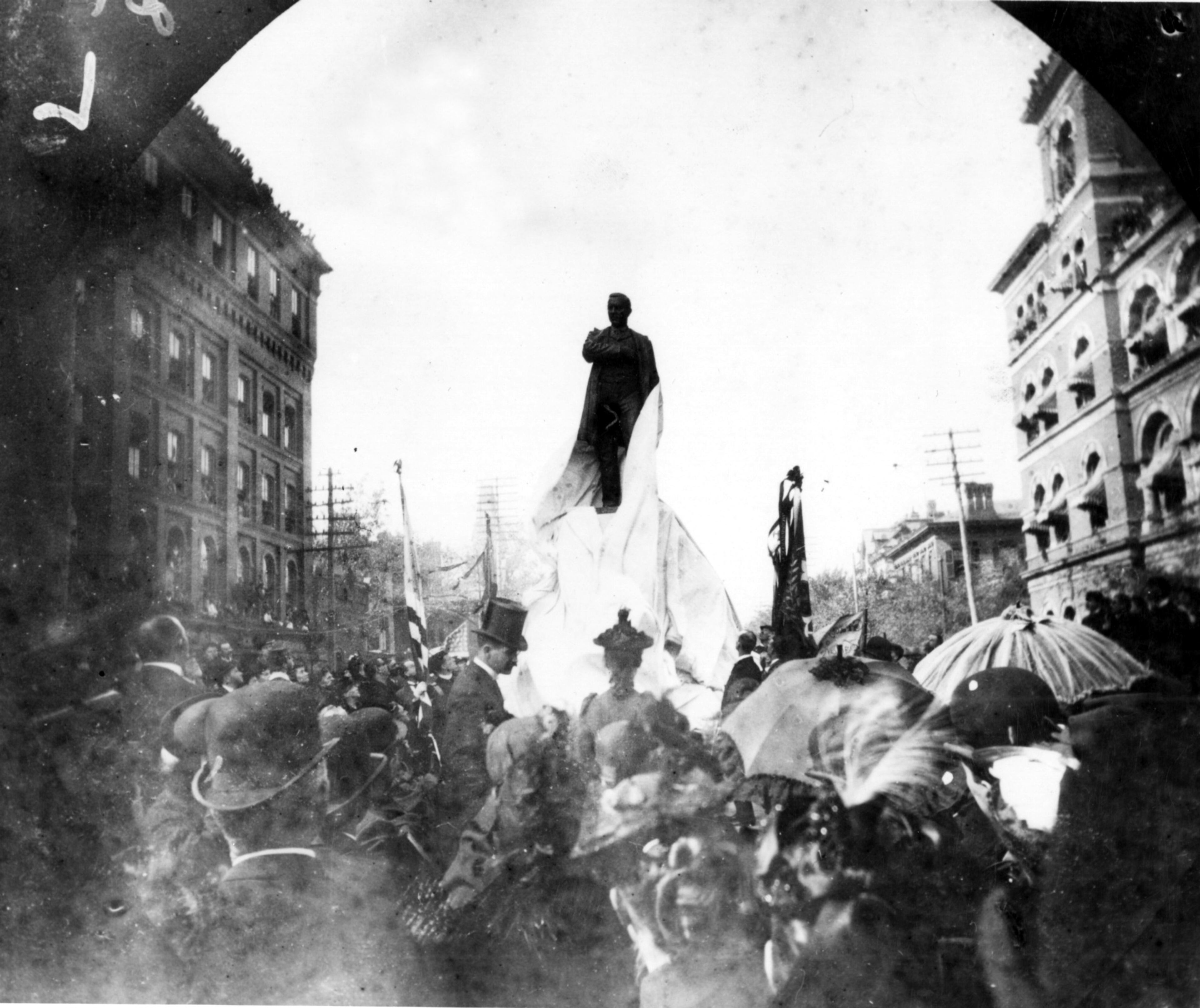 Photo taken on Oct. 21, 1891 shows unveiling of the Henry Grady Statue at Marietta and Forsyth Streets. A crowd of 25,000 attended, even lining the tops of buildings. Building on left is the old Post Office, (currently the Western Union Bldg.) On the right is the old Customs House (55 Marietta St., formerly Fulton National Bank Bldg.)