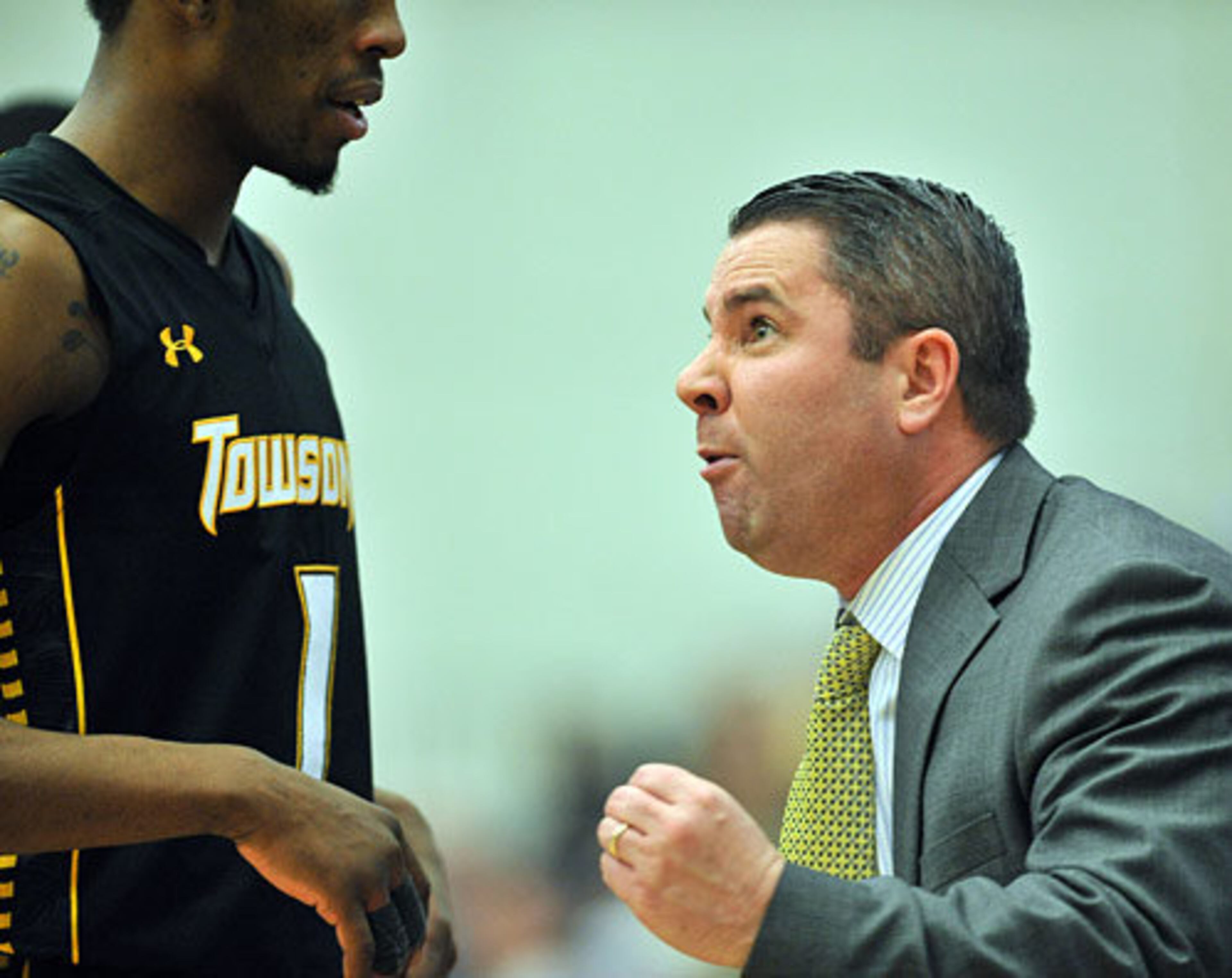 Towson head coach Pat Skerry instructs forward Marcus Damas (1).