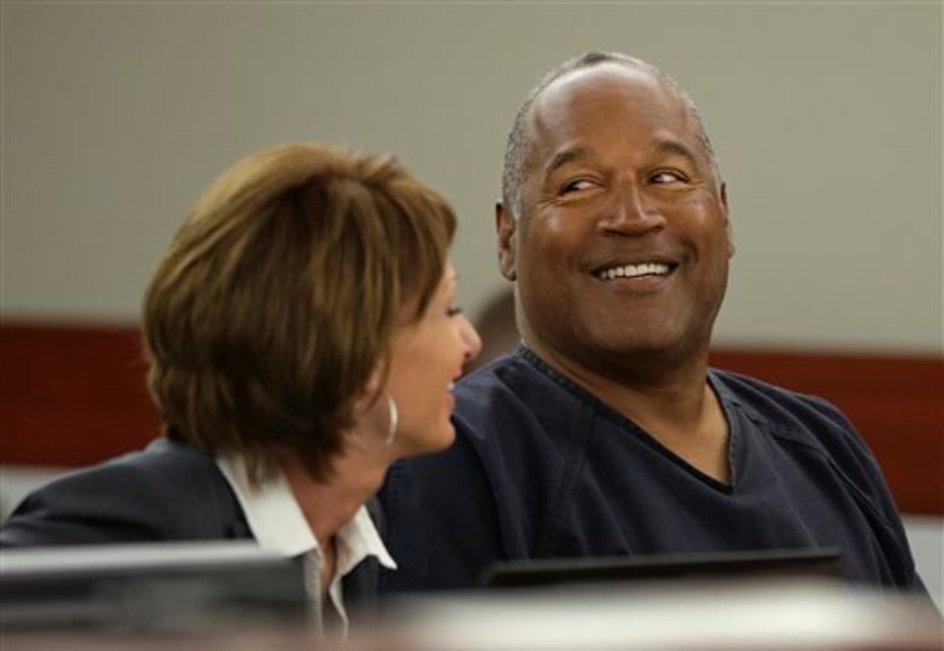 O.J. Simpson, right, talks with his attorney, Patricia Palm in Clark County District Court, Monday, May 13, 2013 in Las Vegas. Simpson, who is currently serving a nine-to-33-year sentence in state prison as a result of his October 2008 conviction on armed robbery and kidnapping charges, is seeking a new trial, claiming that trial lawyer Yale Galanter had conflicted interests and shouldn't have handled Simpson's armed case. (AP Photo/Julie Jacobson, Pool)
