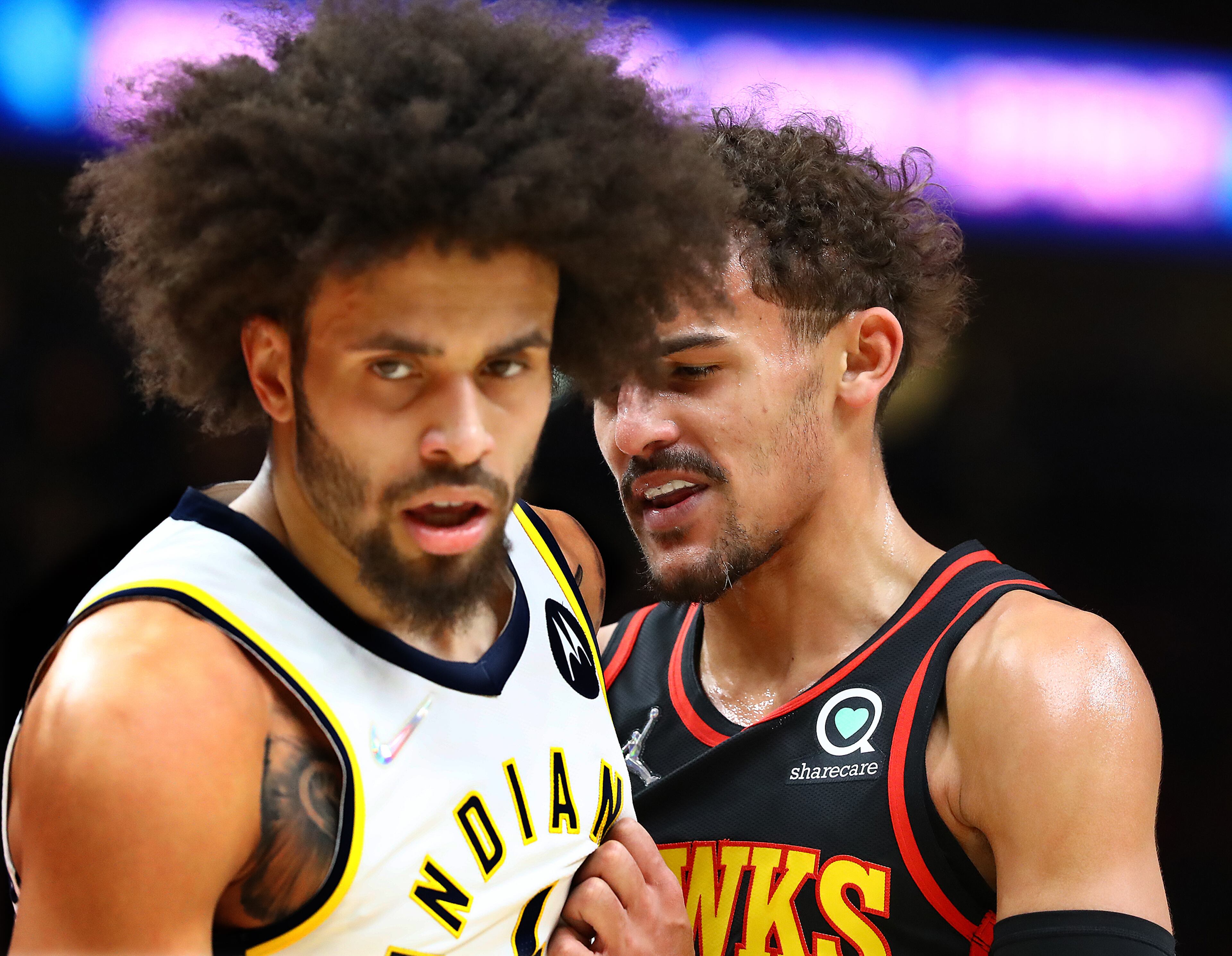 Hawks guard Trae Young (right) mixes it up with Indiana Pacers guard Duane Washington Jr. during the first half in an NBA game on Tuesday, Feb. 8, 2022, in Atlanta. “Curtis Compton / Curtis.Compton@ajc.com”`
