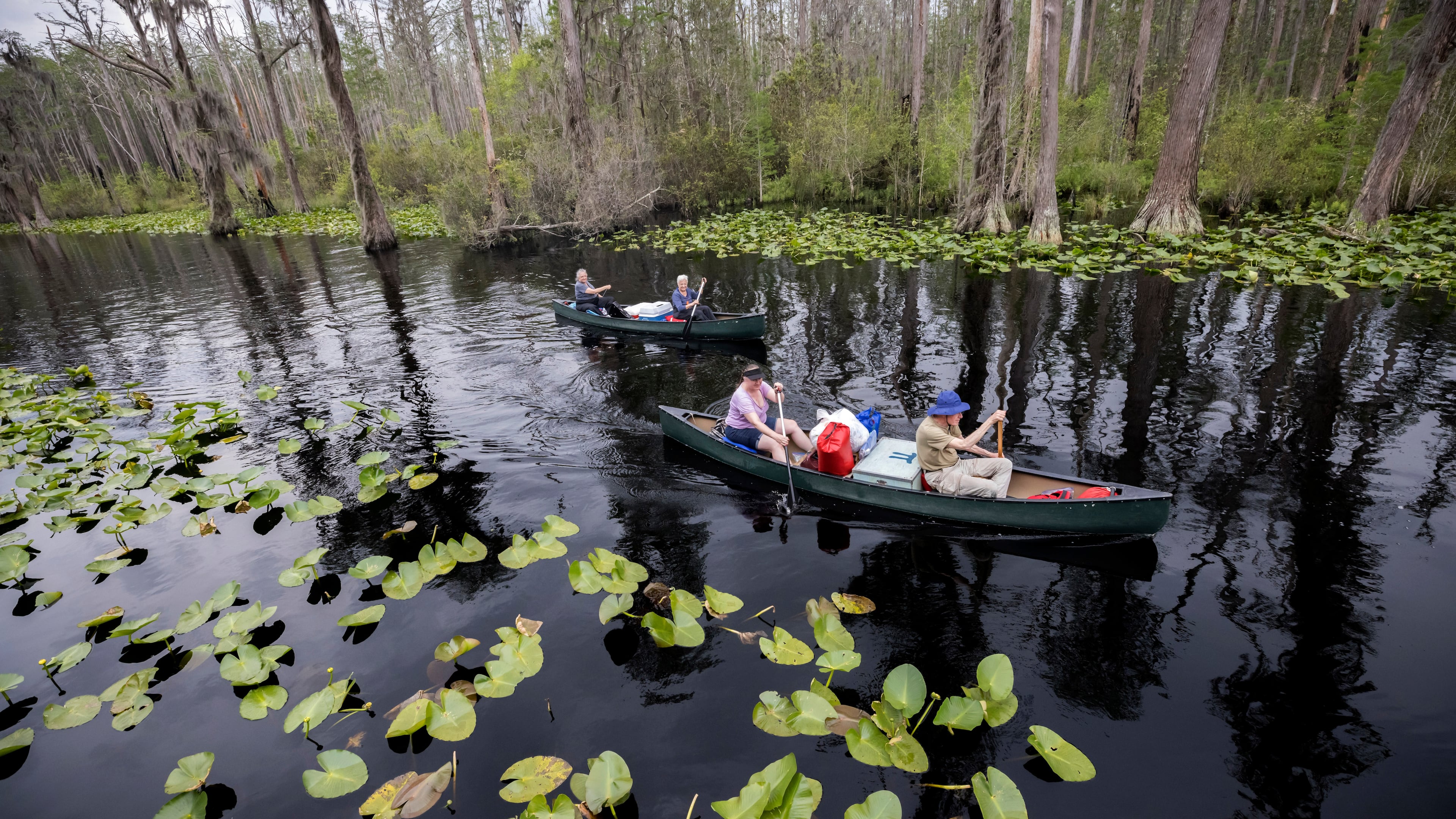 FILE - Visitors return to Stephen C. Foster State Park after an overnight camping trip on the Red Trail in the Okefenokee National Wildlife Refuge in Fargo, Ga., April 6, 2022. (AP Photo/Stephen B. Morton, File)