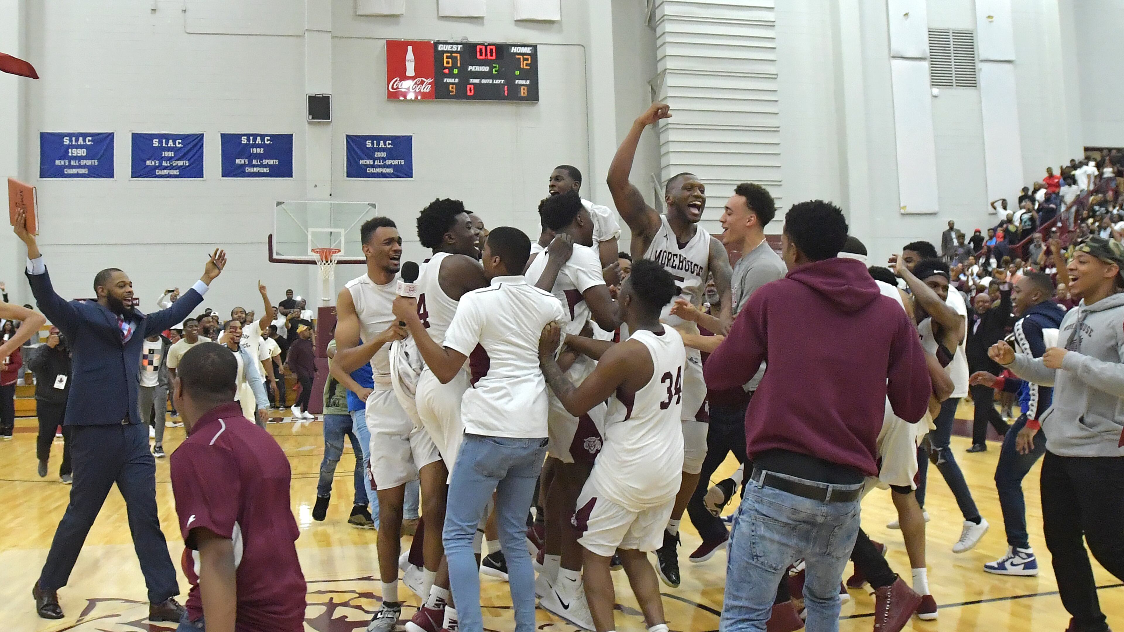 Morehouse players and coaches celebrate their 72-67 victory over Clark Atlanta on Thursday, February 22, 2018. HYOSUB SHIN / HSHIN@AJC.COM