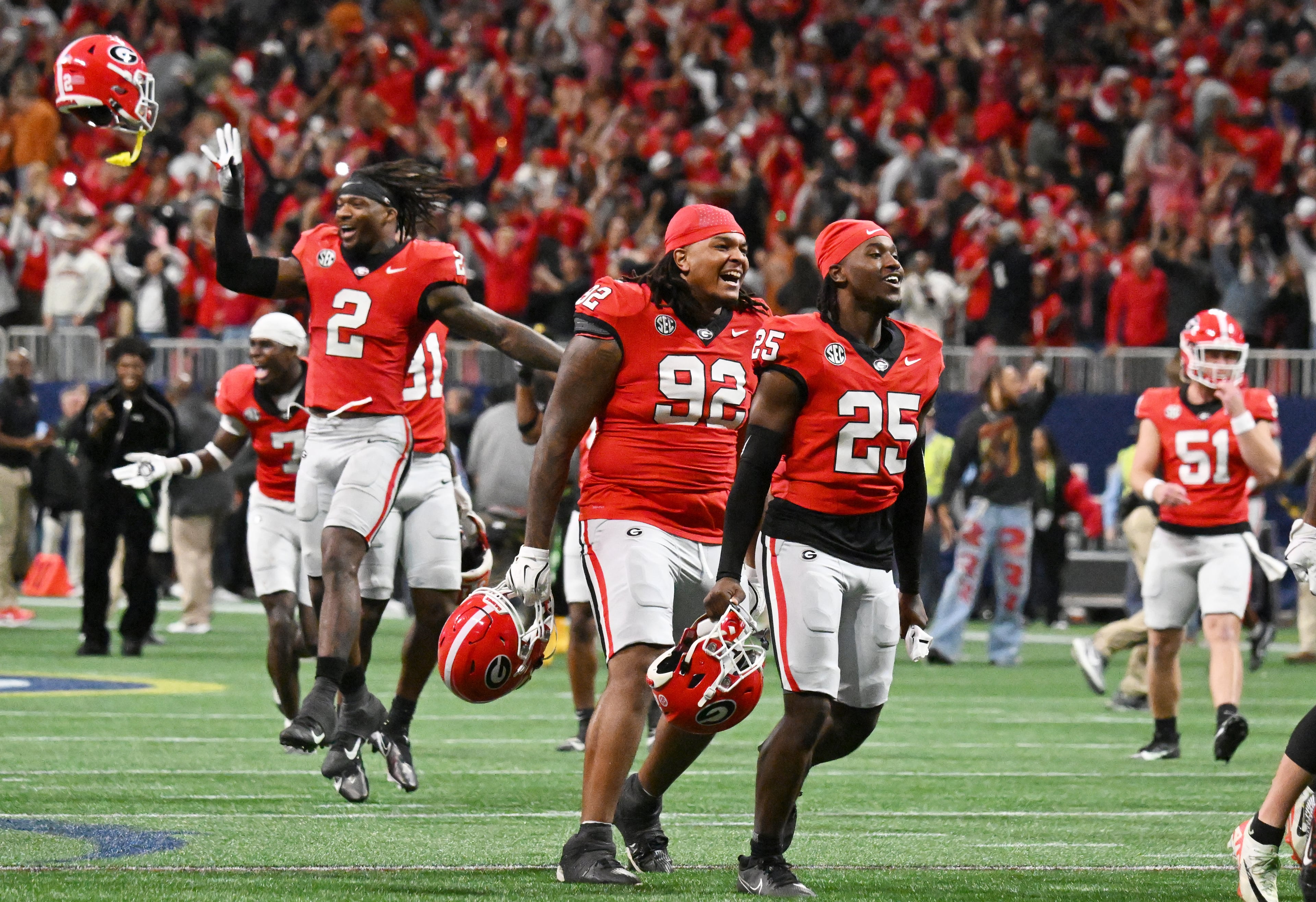 Georgia players celebrate after running back Trevor Etienne scored the game winning touchdown in overtime during the SEC Championship football game at the Mercedes-Benz Stadium, Saturday, December 7, 2024, in Atlanta. Georgia won 22-19 over Texas in overtime. (Hyosub Shin / AJC)