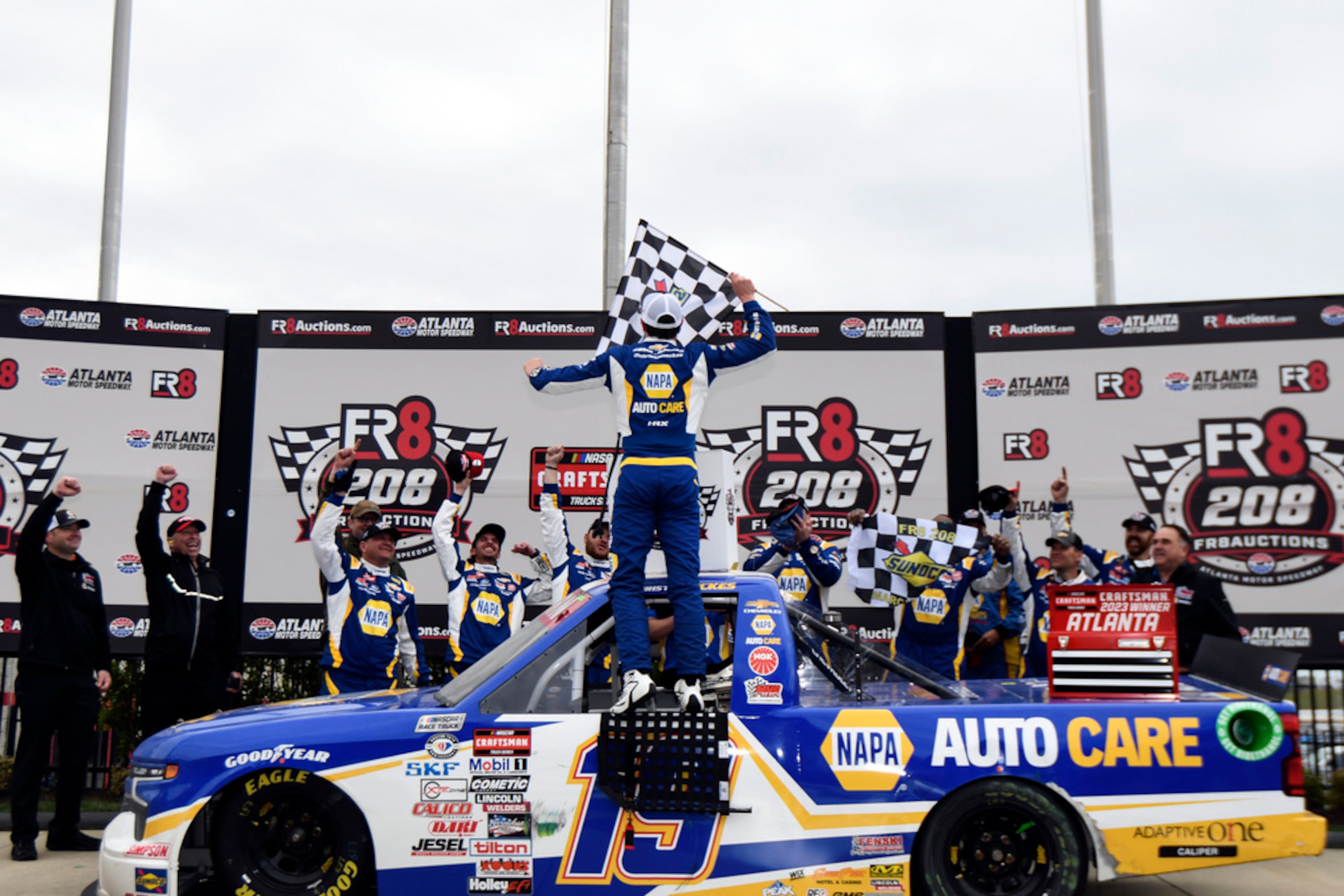 Christian Eckes celebrates a checked flag with crew members after winning the NASCAR Truck Series auto race at Atlanta Motor Speedway on Saturday, March 18, 2023, in Hampton, Ga. (AP Photo/Hakim Wright Sr.)