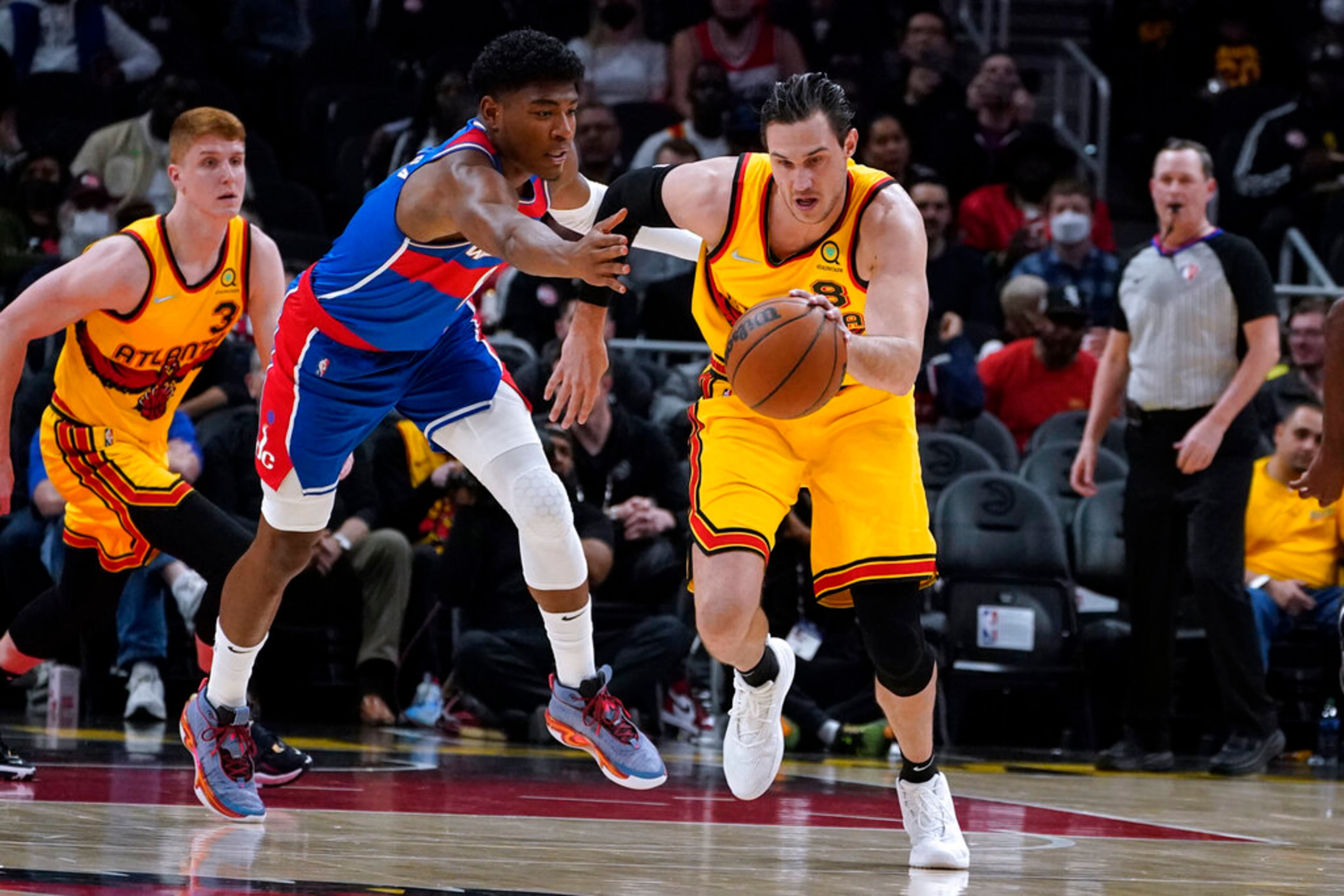 Washington Wizards' Rui Hachimura fouls Atlanta Hawks' Danilo Gallinari, right, during the first half of an NBA basketball game Wednesday, April 6, 2022, in Atlanta. (AP Photo/John Bazemore)