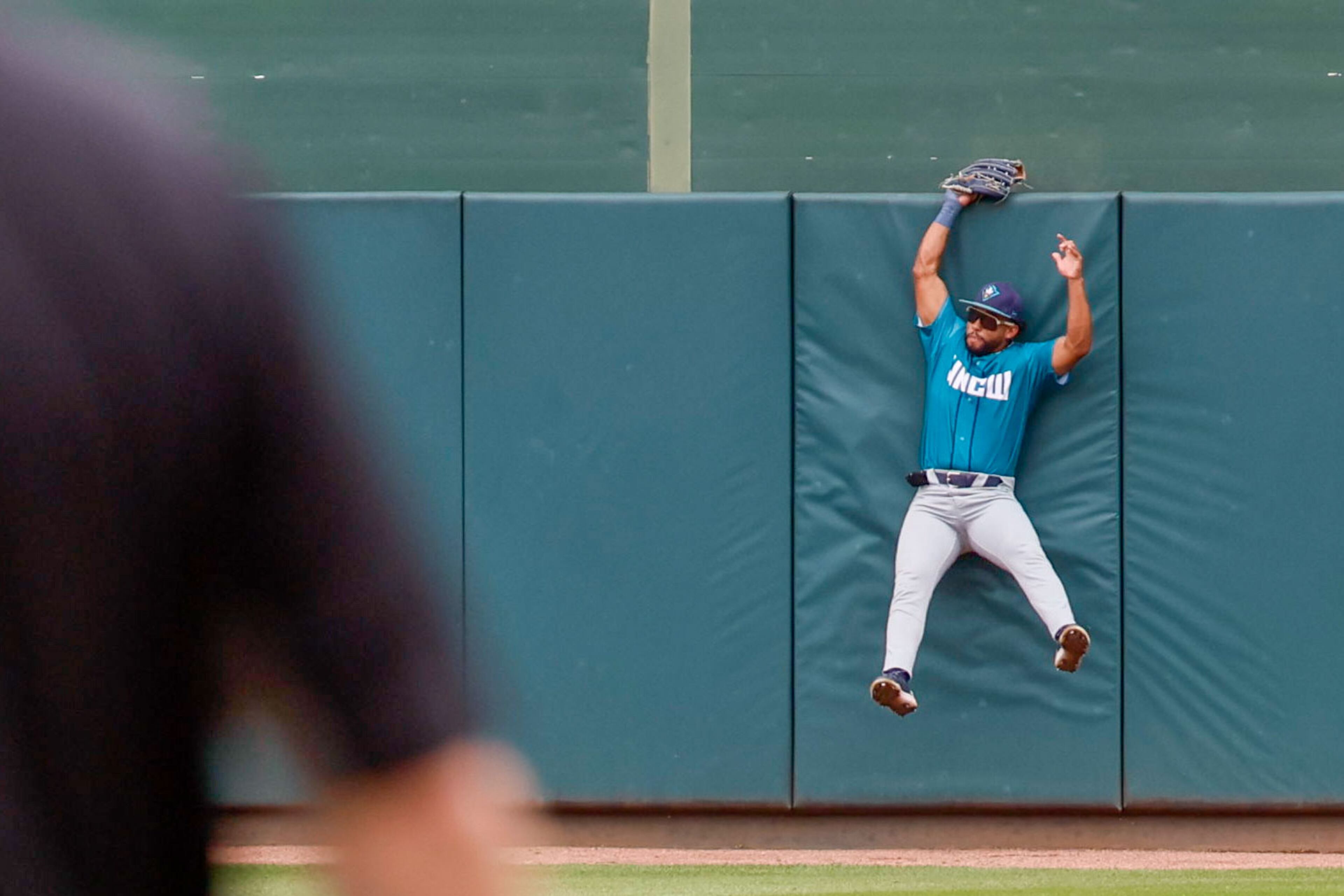 UNC Wilmington center fielder Trevor Marsh crashes against the wall after catching a fly by Georgia Tech right fielder Bobby Zmarzlack during the NCAA Tournament Regional at Foley Field on Sunday, June 2, 2024, in Athens.
(Miguel Martinez / AJC)