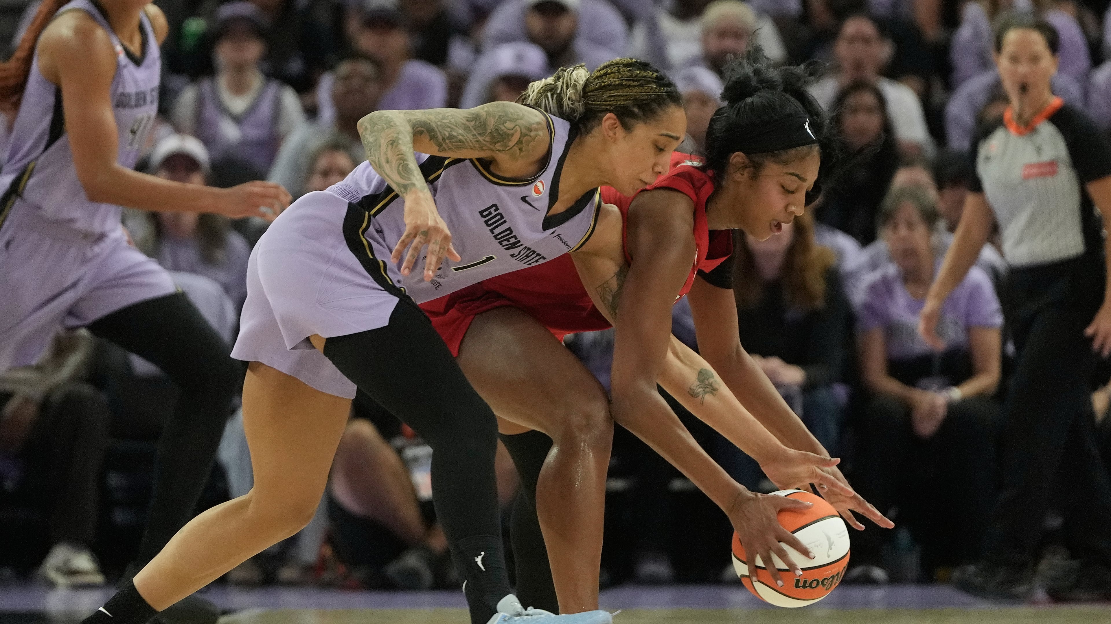 Golden State Valkyries forward Gabby Williams (left) reaches for the ball against Atlanta Dream forward Angel Reese during the first half of Game 1 of the WNBA basketball finals, Saturday, Oct. 17, 2026, in San Francisco. (Jeff Chiu/AP)
