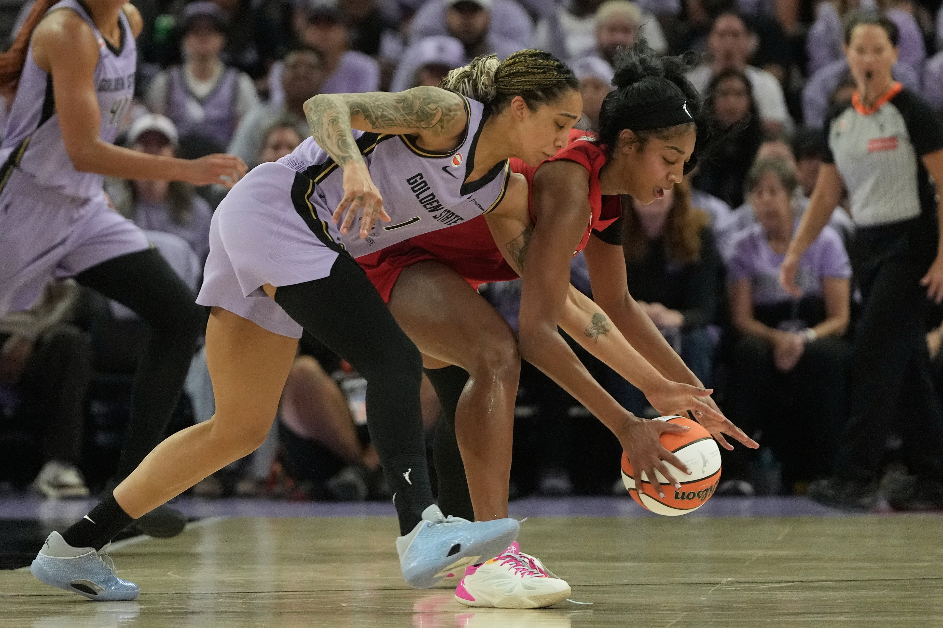 Golden State Valkyries forward Gabby Williams (left) reaches for the ball against Atlanta Dream forward Angel Reese during the first half of Game 1 of the WNBA basketball finals, Saturday, Oct. 17, 2026, in San Francisco. (Jeff Chiu/AP)