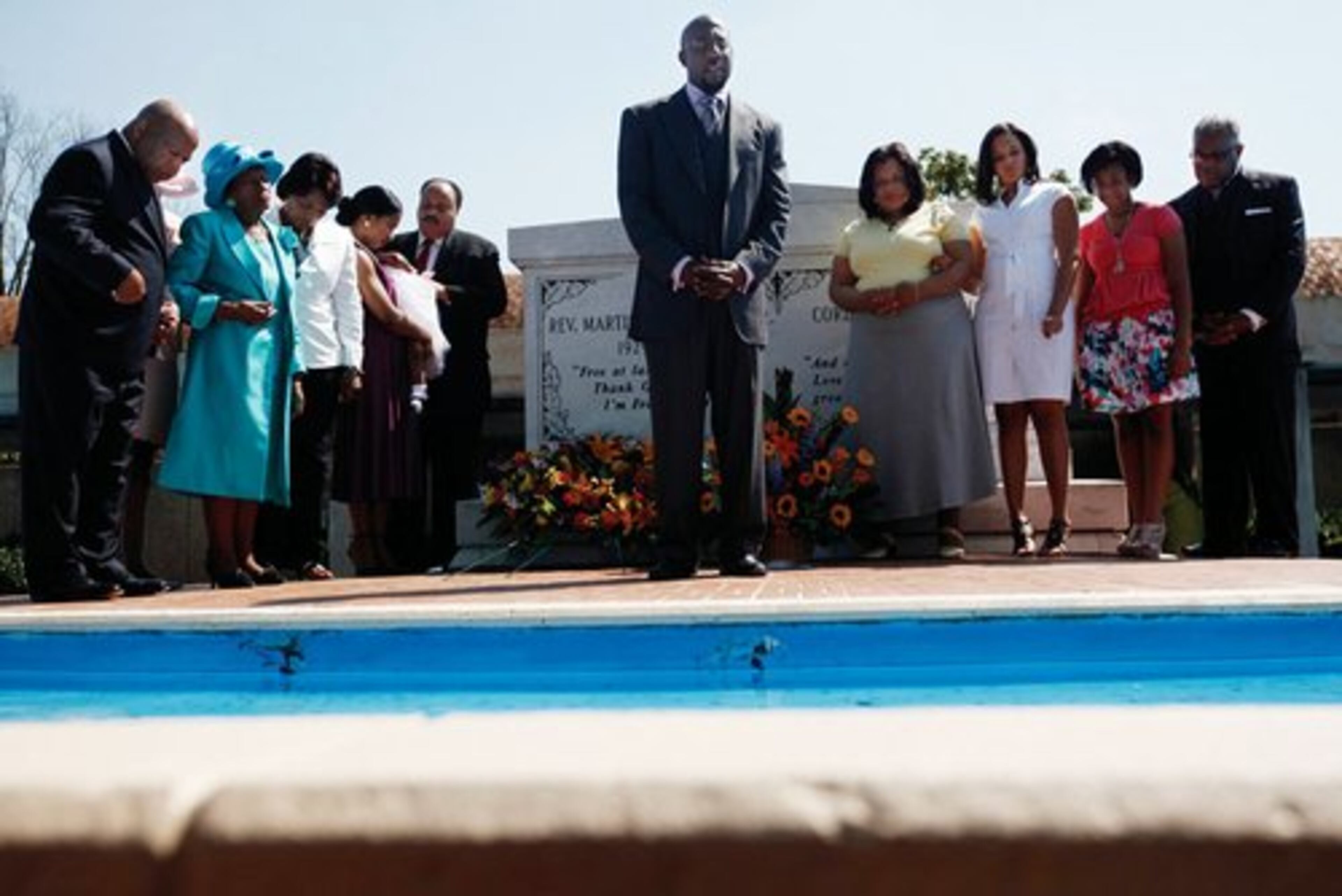 The Rev.Raphael Warnock of Ebenezer Baptist Church leads friends and family of Martin Luther King Jr. in a prayer.