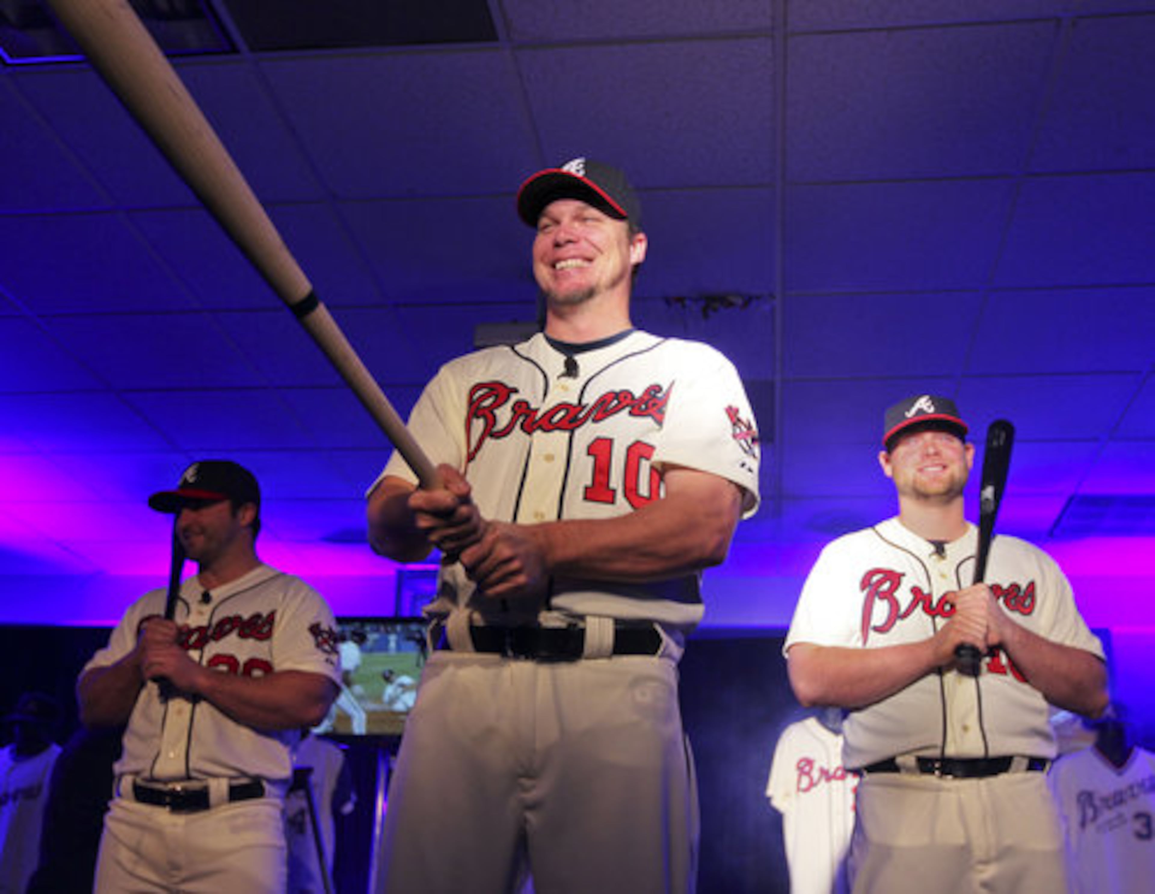 Left to right - Braves players, Dan Uggla, Chipper Jones and Brian McCann show off the new 60s-inspired uniforms.