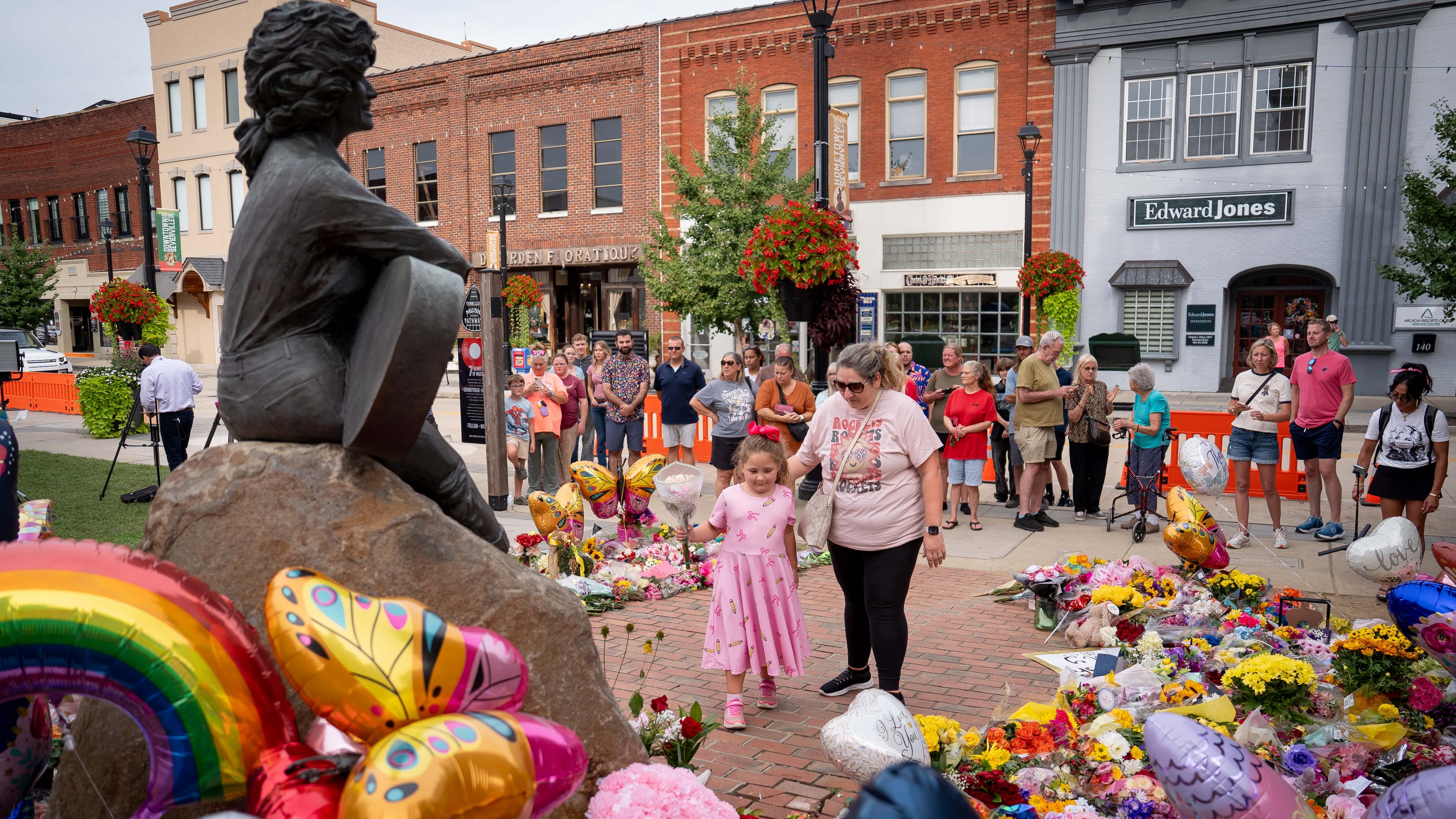 People lay flowers at a memorial honoring the late Dolly Parton in Sevierville, Tenn., on Wednesday, Aug. 26, 2026. (Camden Hall/AP)